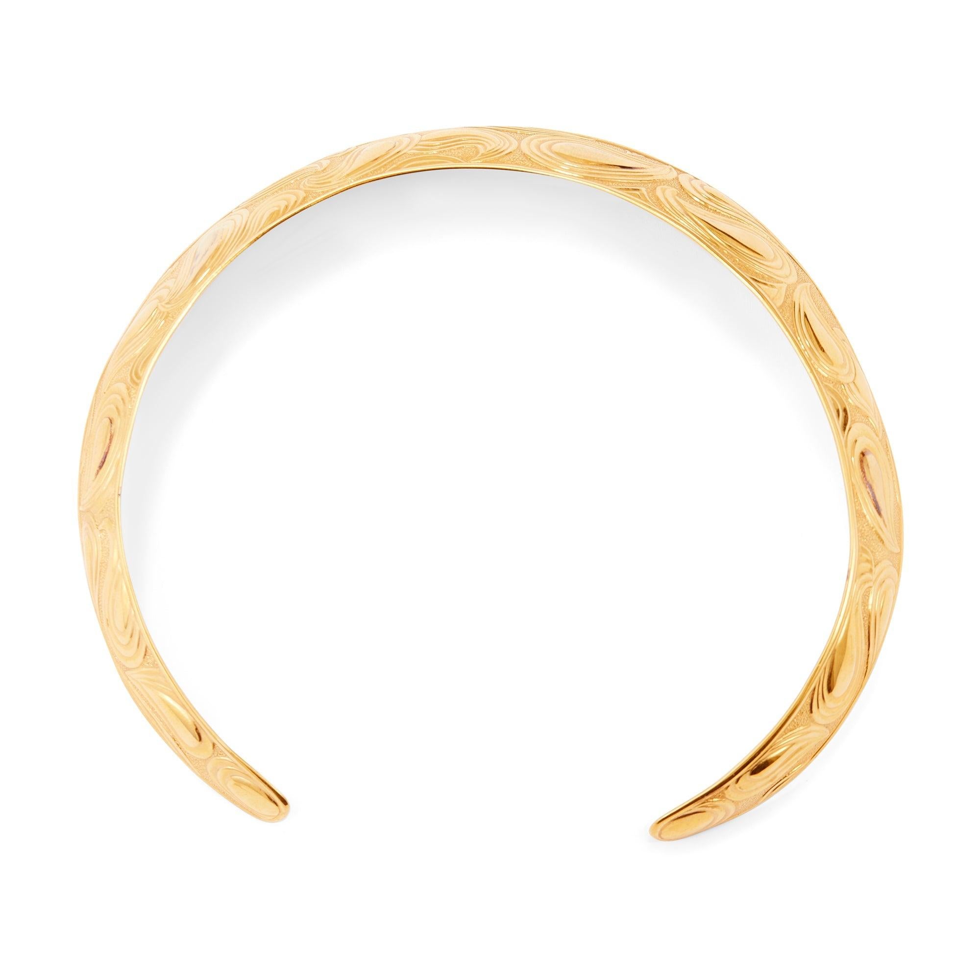 This necklace was created by French luxury fashion house Lanvin in the 1970s. Designed in a torque collar style, it is crafted from gold-toned metal.  During the 1970s, Lanvin’s jewellery designs embraced the decade’s free-spirited nature. This