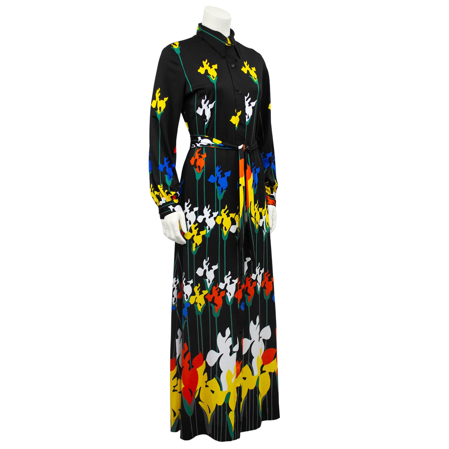 Graphic 1970s Lanvin polyester maxi dress. Black with vibrant primary colour iris flowers. Flowers gradually get bigger towards hem. Shirt dress style, with collar and buttons. Matching optional belt can be tied at waist. Excellent vintage