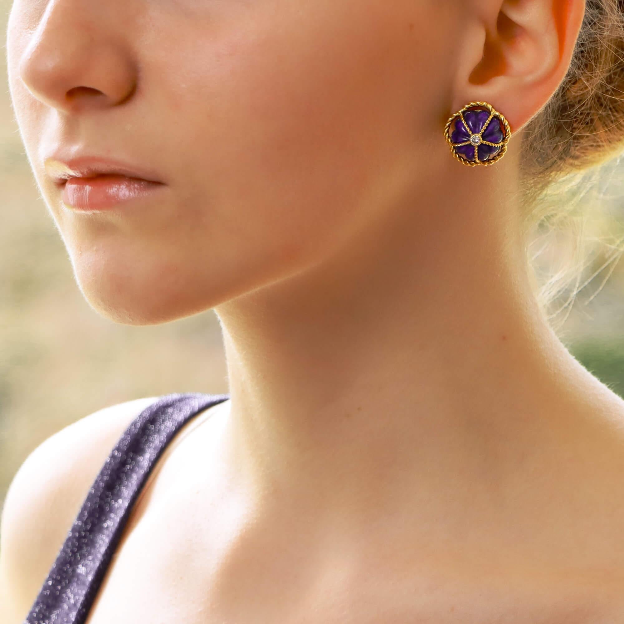A beautiful pair of carved lapis lazuli and diamond domed earrings set in 18k yellow gold.

Each earring is predominantly composed of a large carved piece of royal blue lapis lazuli which is encased within a framework of twisted yellow gold wire.