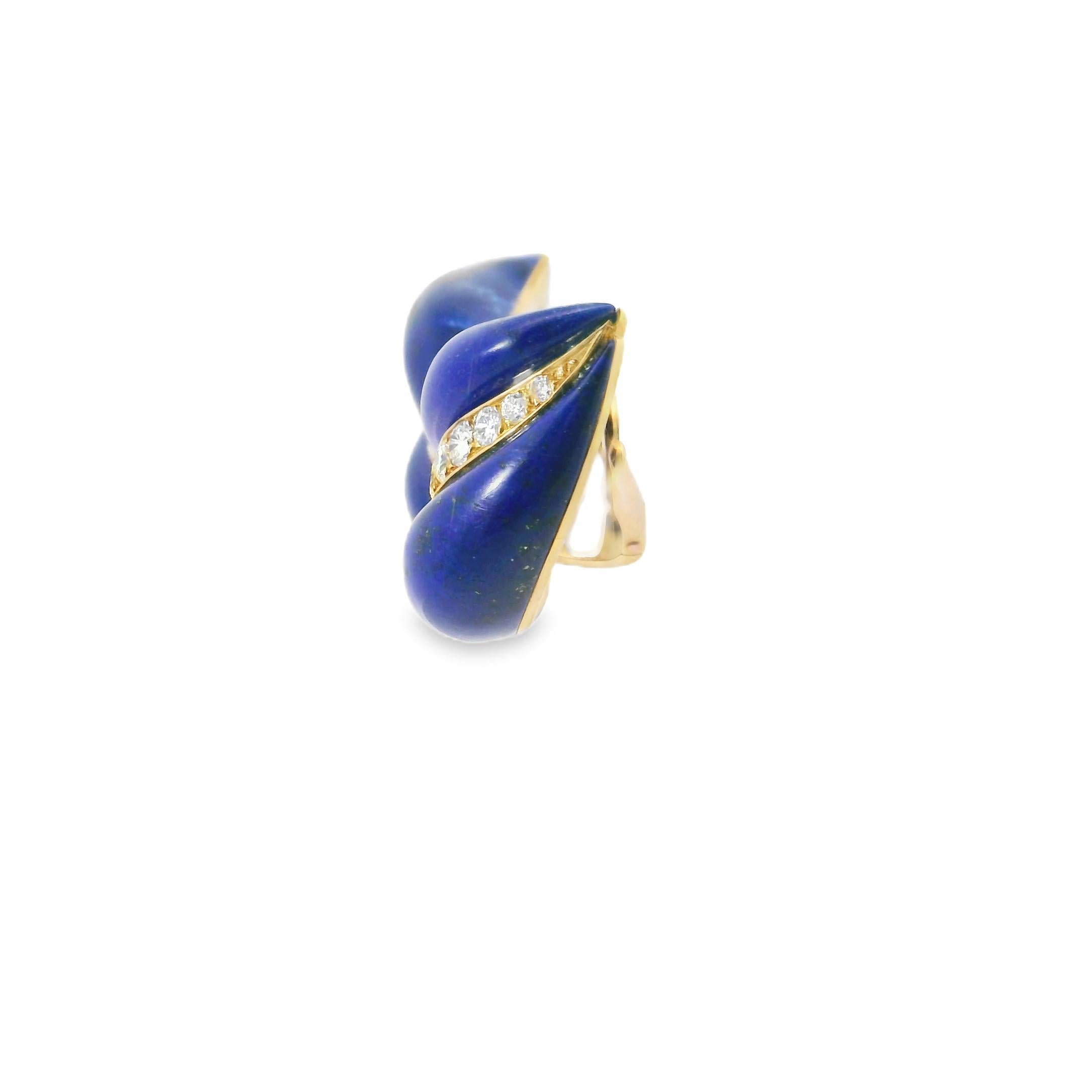 A striking and sculptural pair of 1970s lapis lazuli and diamond earrings, crafted in 18k yellow gold and signed by the esteemed French jeweler Georland. These elegant earrings are designed in an organic flame-like motif, with smooth cabochon lapis