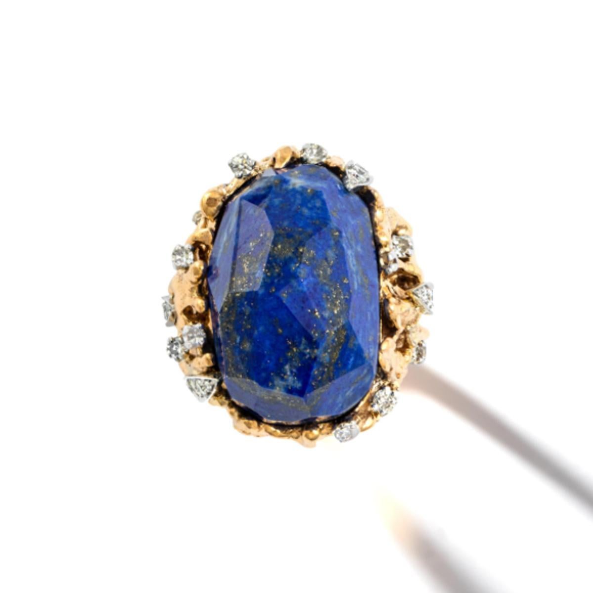 Lapis Lazuli and Diamond yellow gold Ring.
Incredibly designed holding an important raw cut Lapis Lazuli surrounded by diamonds.
Unique piece. Mark 14k.
Circa 1970.

Size 8 (57).
Height on top part: 0.79 inch (2.00 centimeters)
Length on finger top