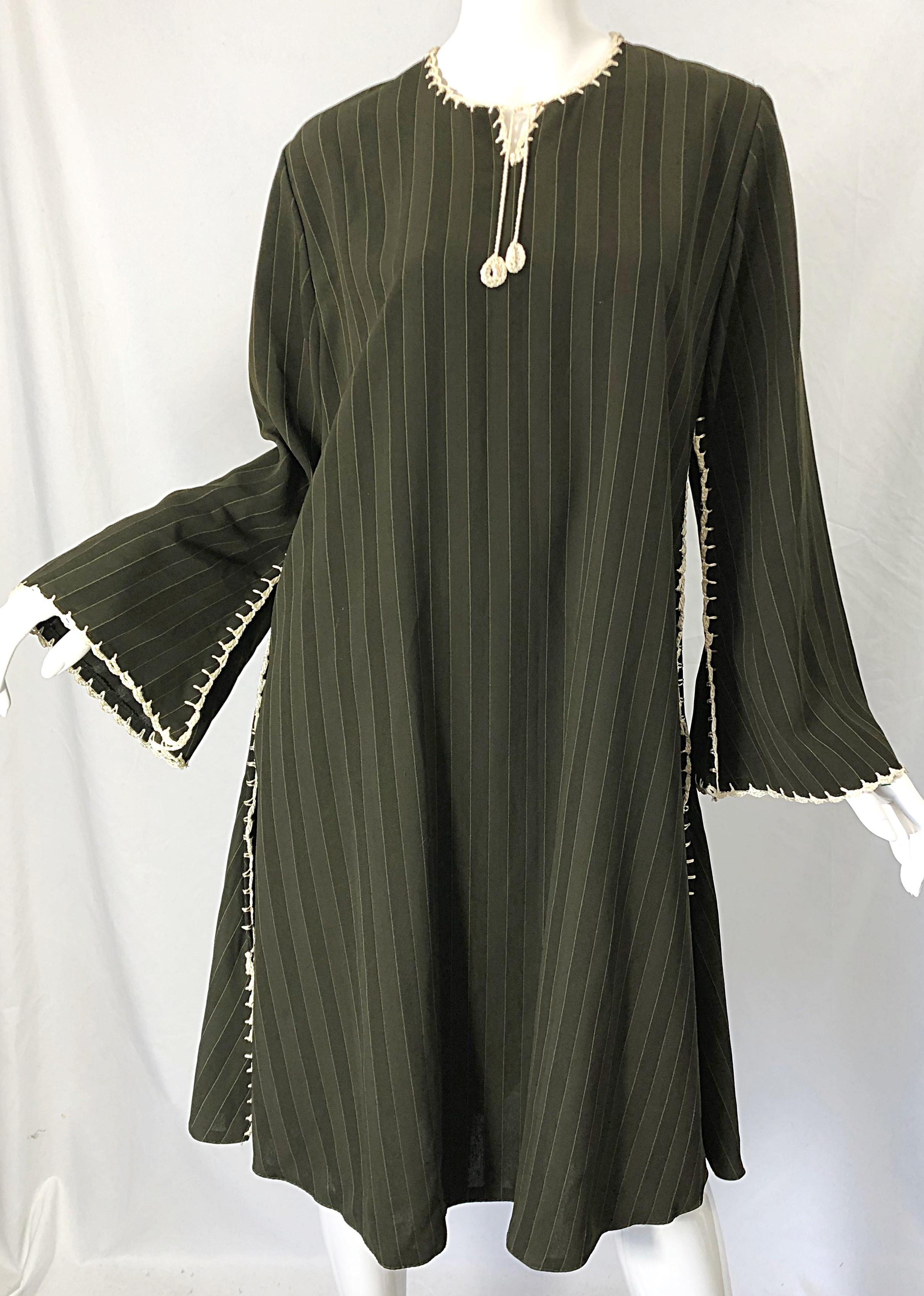 Chic 1970s hunter green, brown and ivory pinstriped crochet bell sleeve tunic dress ! Features hand crochet work down the sides of the dress, collar, and sleeves. Simply slips over the head. Great alone, or as a cover up with leggings. 
In great