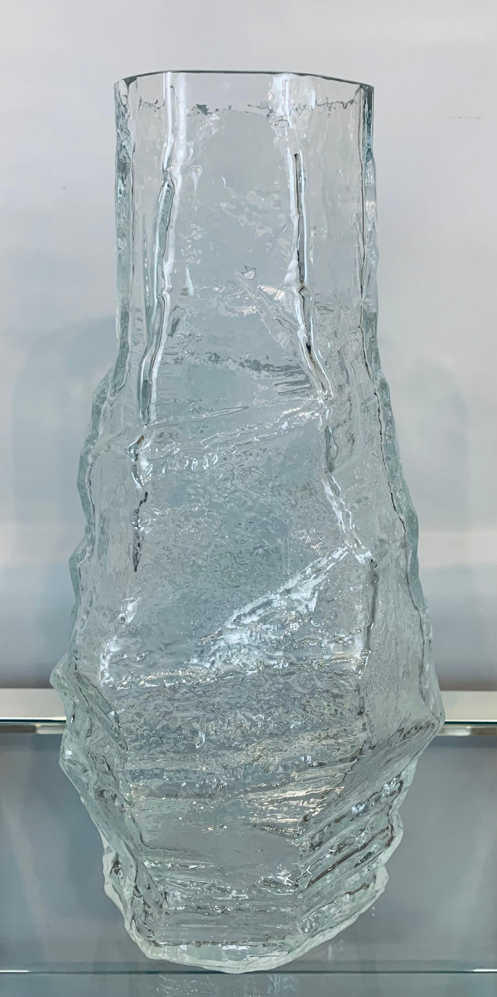 A large and unusual 1970s thick and heavy 'glacier' clear glass vase manufactured by Peill & Putzler of Germany. In very good vintage condition with some small scratches on the base commensurate with its age.

Dimensions

Diameter of the top: