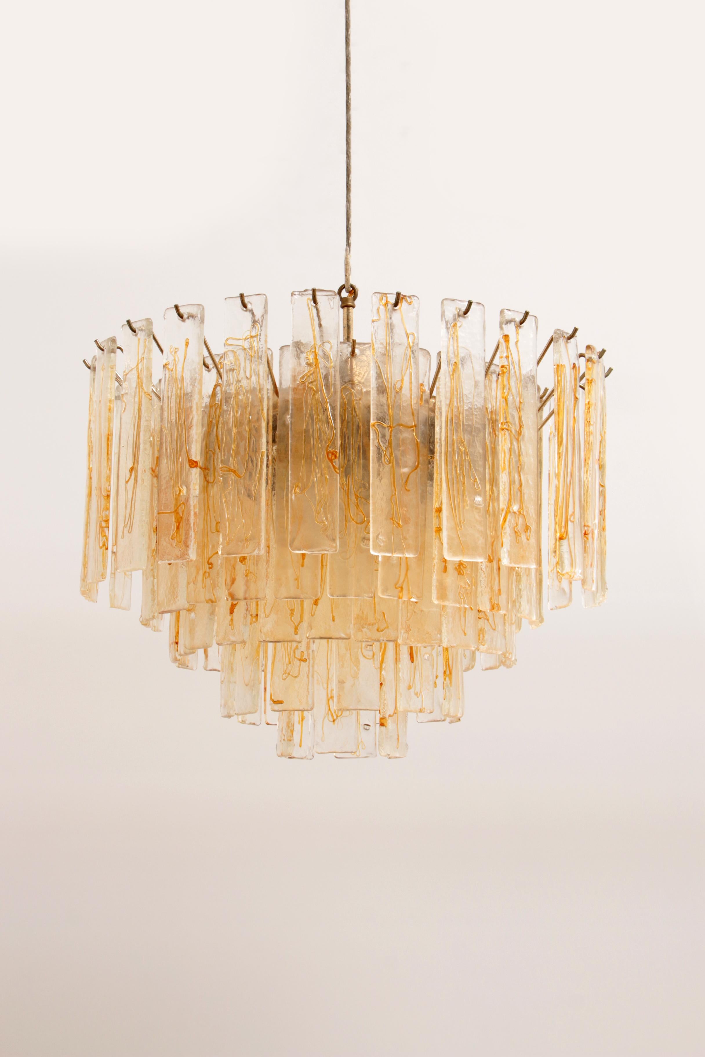 The absolutely fantastic vintage Murano glass large chandelier made in Italy in the 1970s. This lamp has 5 rings that overlap beautifully. The lamp consists of glass plates of Murano glass, you can view the glass from 2 sides, there is a beautiful