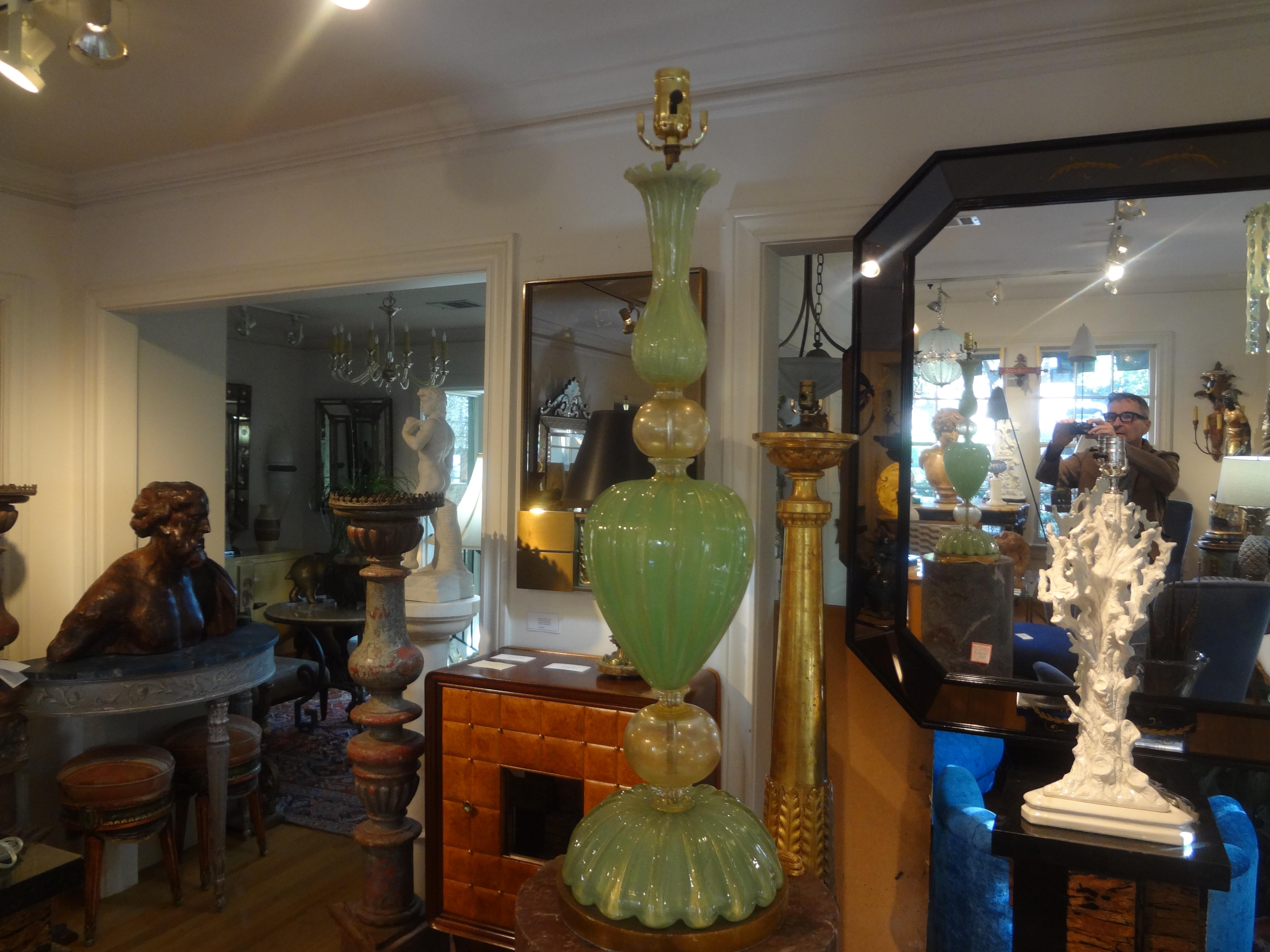 Large Murano Glass Lamp By Seguso.
This stunning Postmodern Murano lamp is the most beautiful green and gold glass on a giltwood base. Our lovely Hollywood Regency Murano lamp has been newly wired with a new socket for the U.S. market.