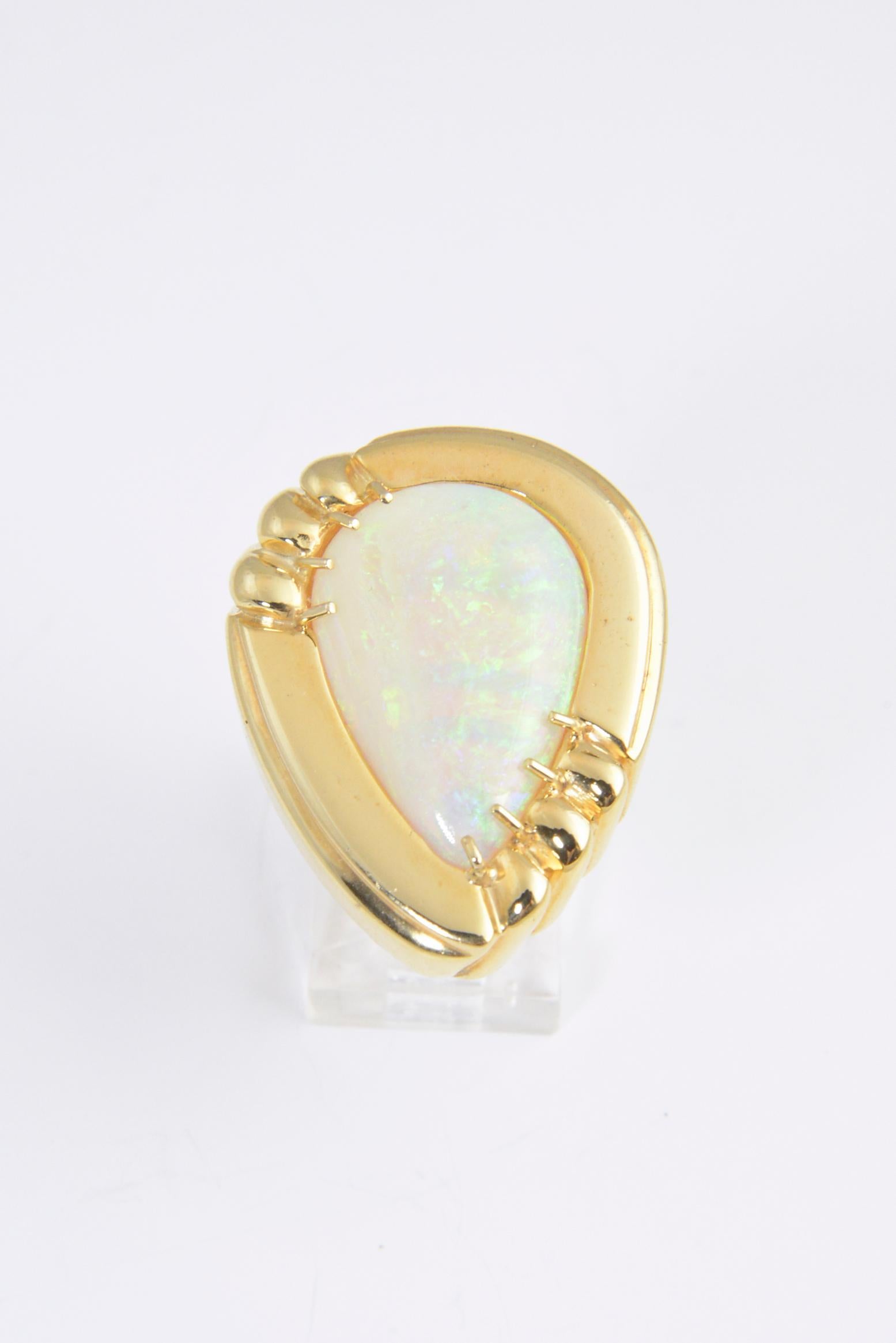 Large statement cocktail ring featuring a pear shaped opal mounted in a 1970s 14k yellow gold stylized frame. 
US Size: 6. It can be resized.