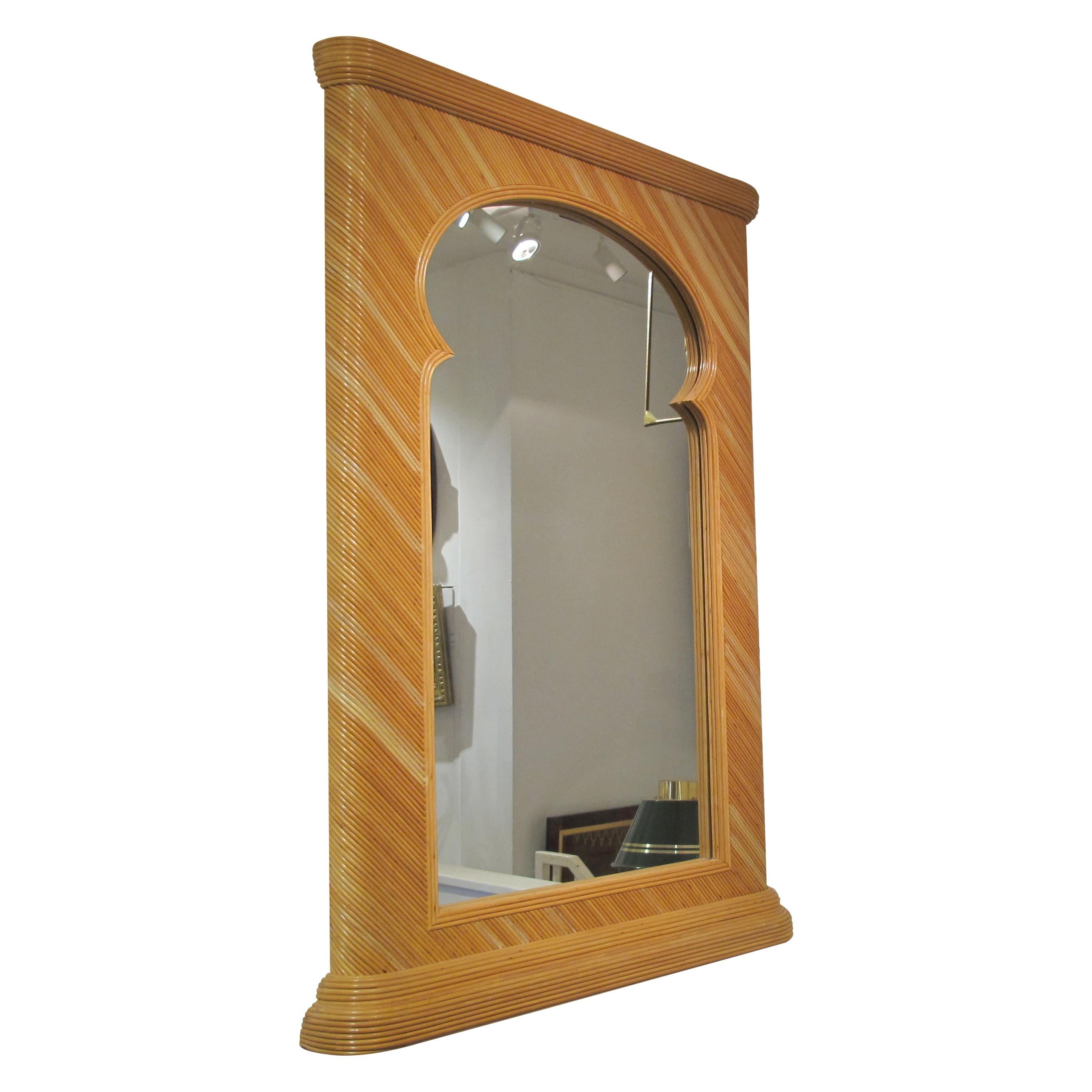 A large pencil reed rattan mirror attributed to Vivai Del Sud, from the 1970s. The mirror features a robust, rectangular frame crafted from tightly woven rattan in a diagonal pattern, characteristic of Vivai Del Sud designs. The upper portion of the