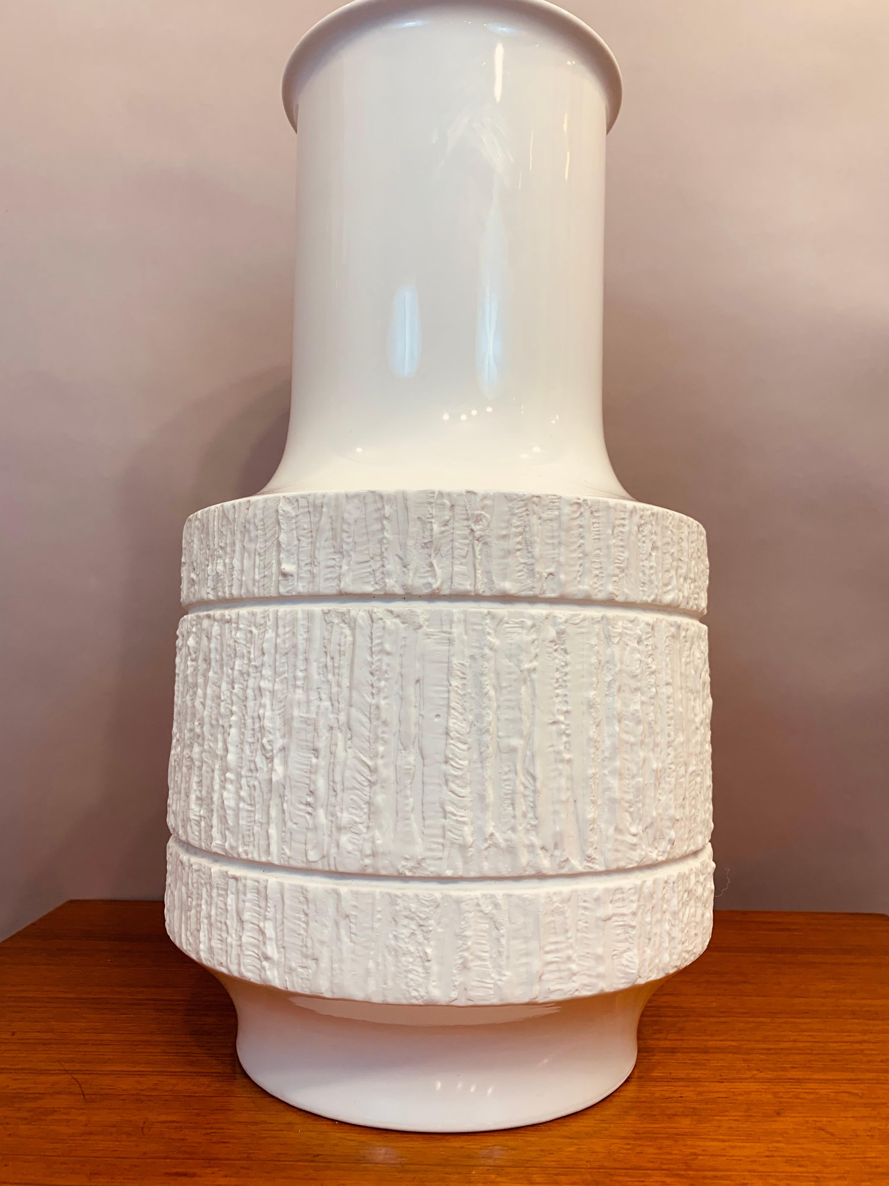 A very large 1970s textured bisque op art porcelain vase which was produced by Thomas, Germany and designed by Richard Scharrer. The textured central surface contrasts beautifully with the polished glazed neck and base. The manufacturer's stamp is