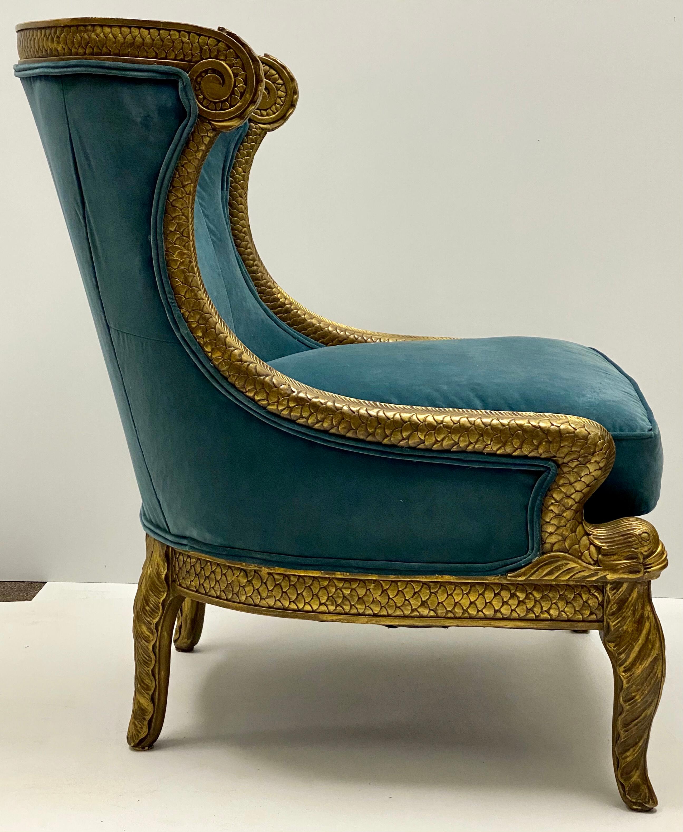 This is a wonderful large scale midcentury Erwin-Lambeth dolphin chair recently upholstered in a blue/teal velvet. The carved giltwood frame wraps around the chair ending at dolphin arms and scaled legs. It is in very good condition.