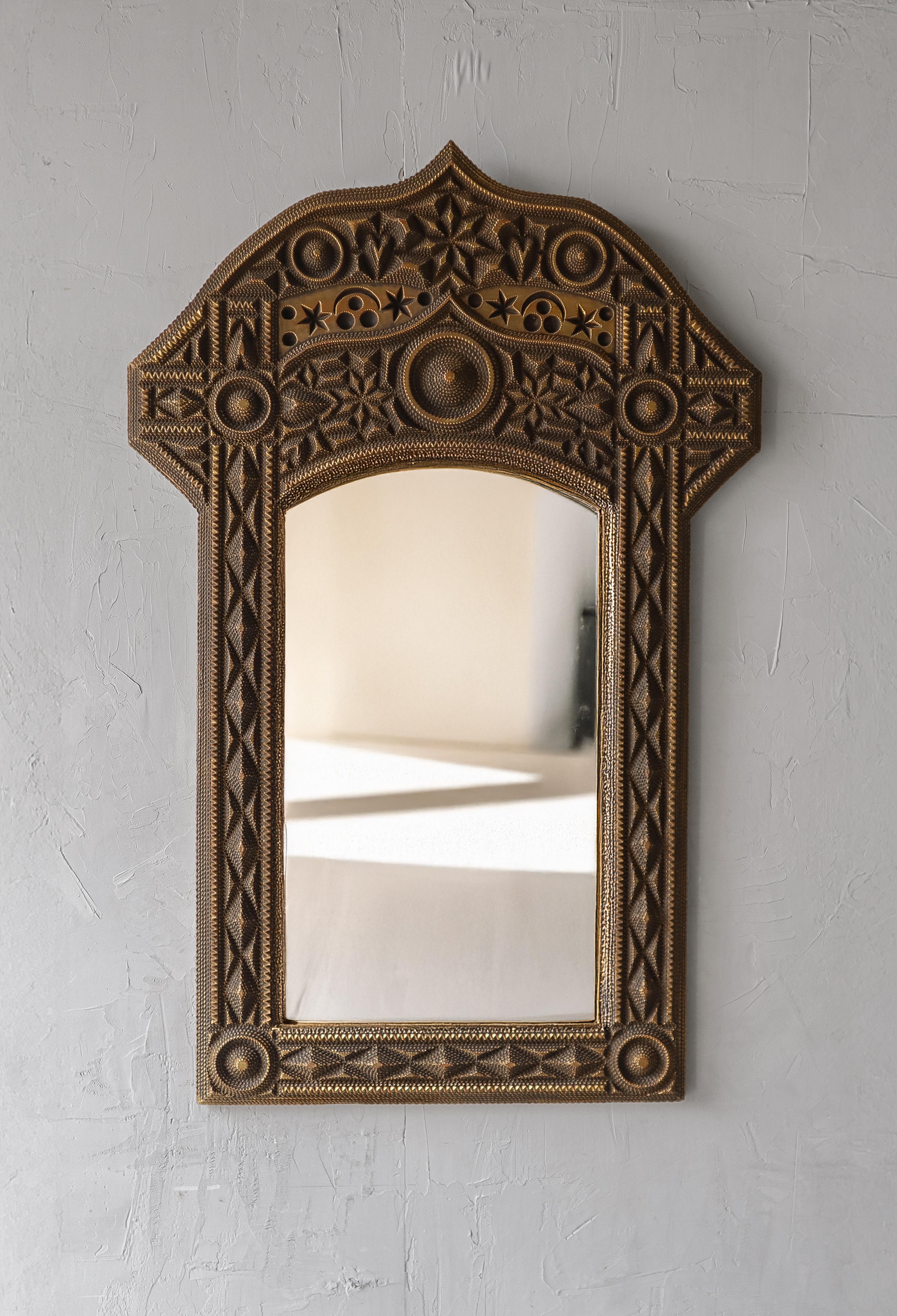 This mirror is a stunning example of Tramp Art style.  Tramp art is a folk art style known for its meticulous hand-carved layering and geometric precision.   

Although this mirror is not made of stacked wood, instead of resin covered polystyrene,