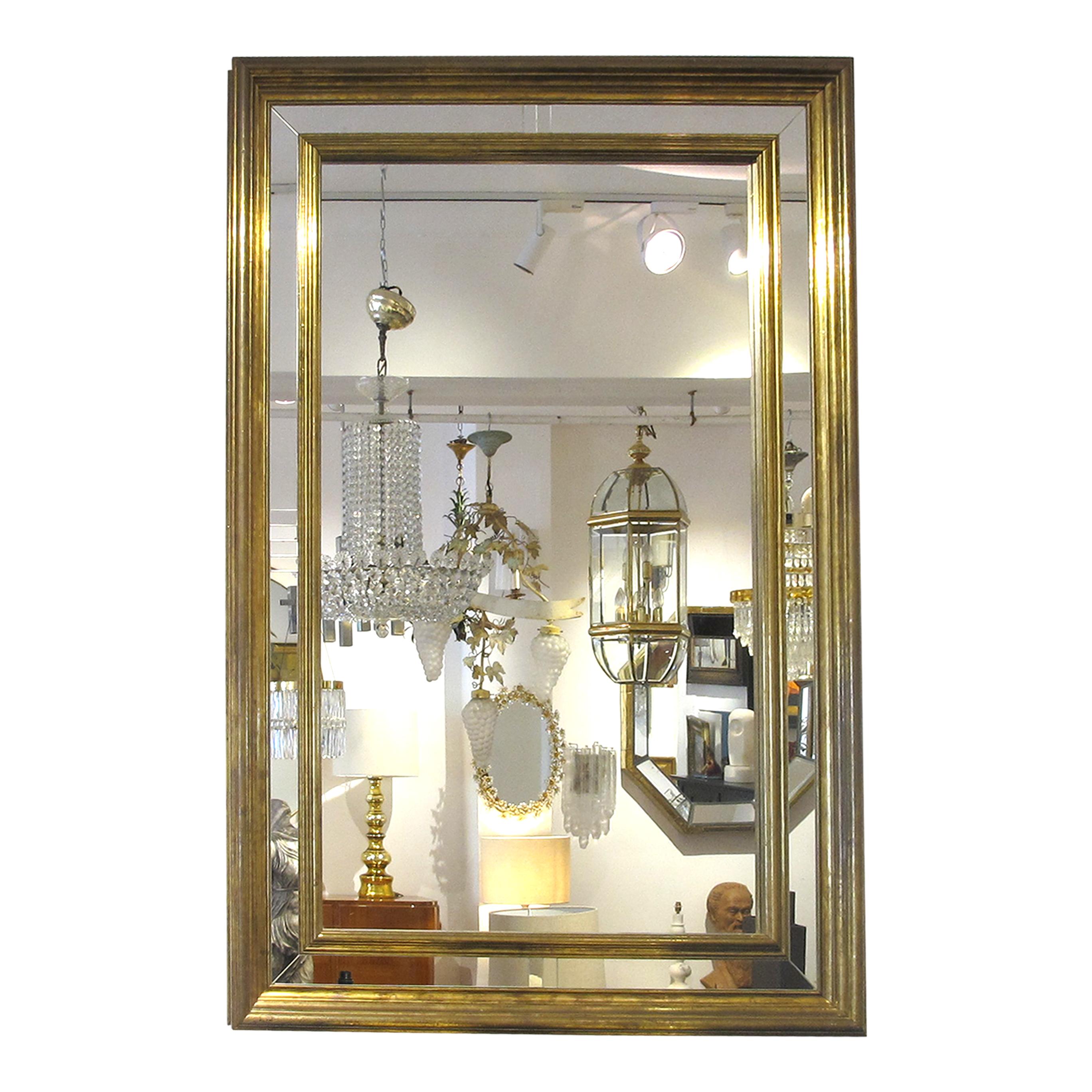 1970s Large Spanish rectangular brass-clad multi-sectional mirror by Rodolfo Dubarry. The mirror's design is further enhanced by its unique multi-sectional composition. Divided into several distinct sections, each pane of glass is discreetly framed