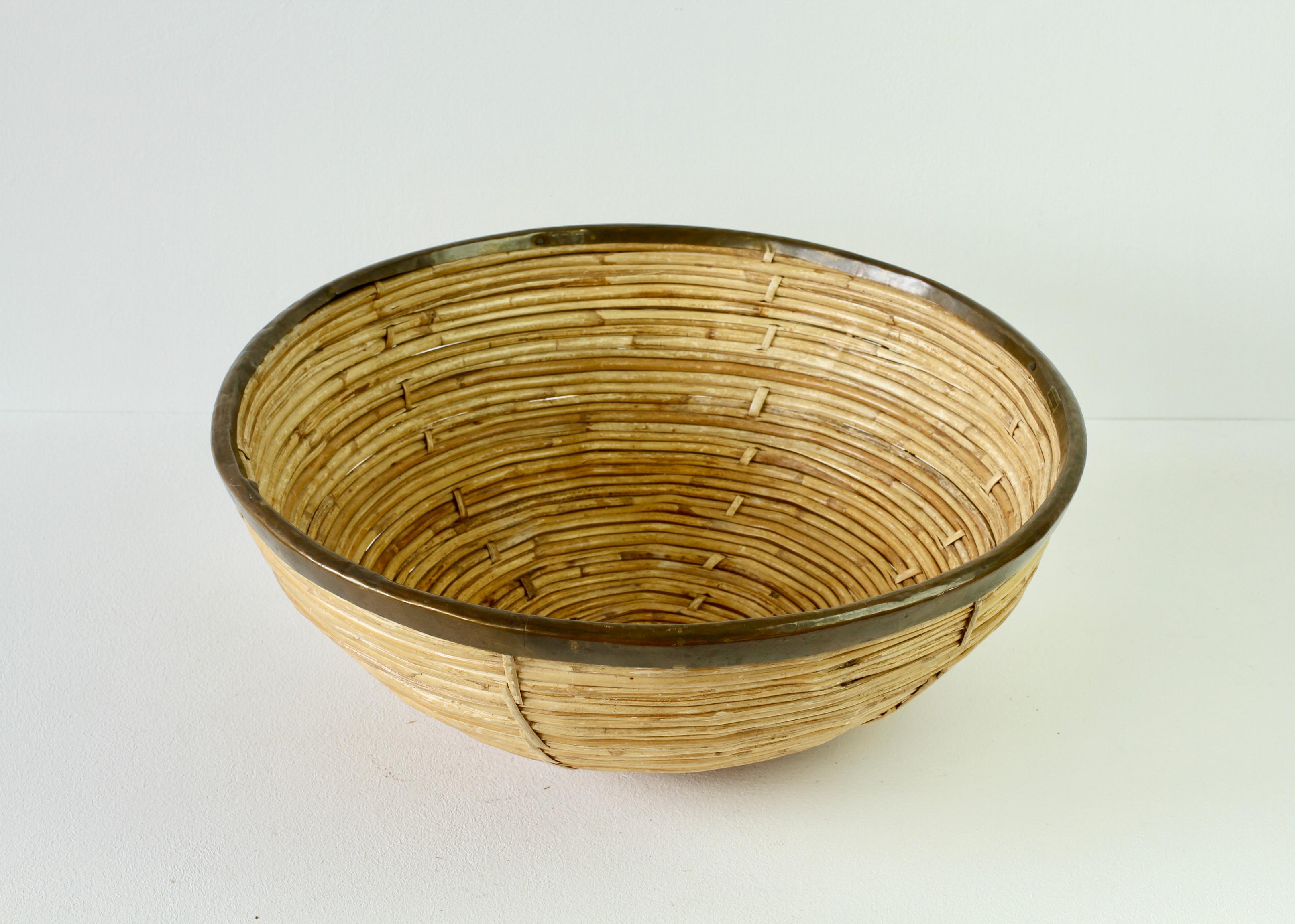 Large circular Mid-Century Hollywood Regency Gabriella Crespi style round bowl or dish made in Italy, circa 1970s. Made of weaved / woven rattan / wicker and bamboo with a patinated brass rim detail which finishes the piece perfectly. A must have