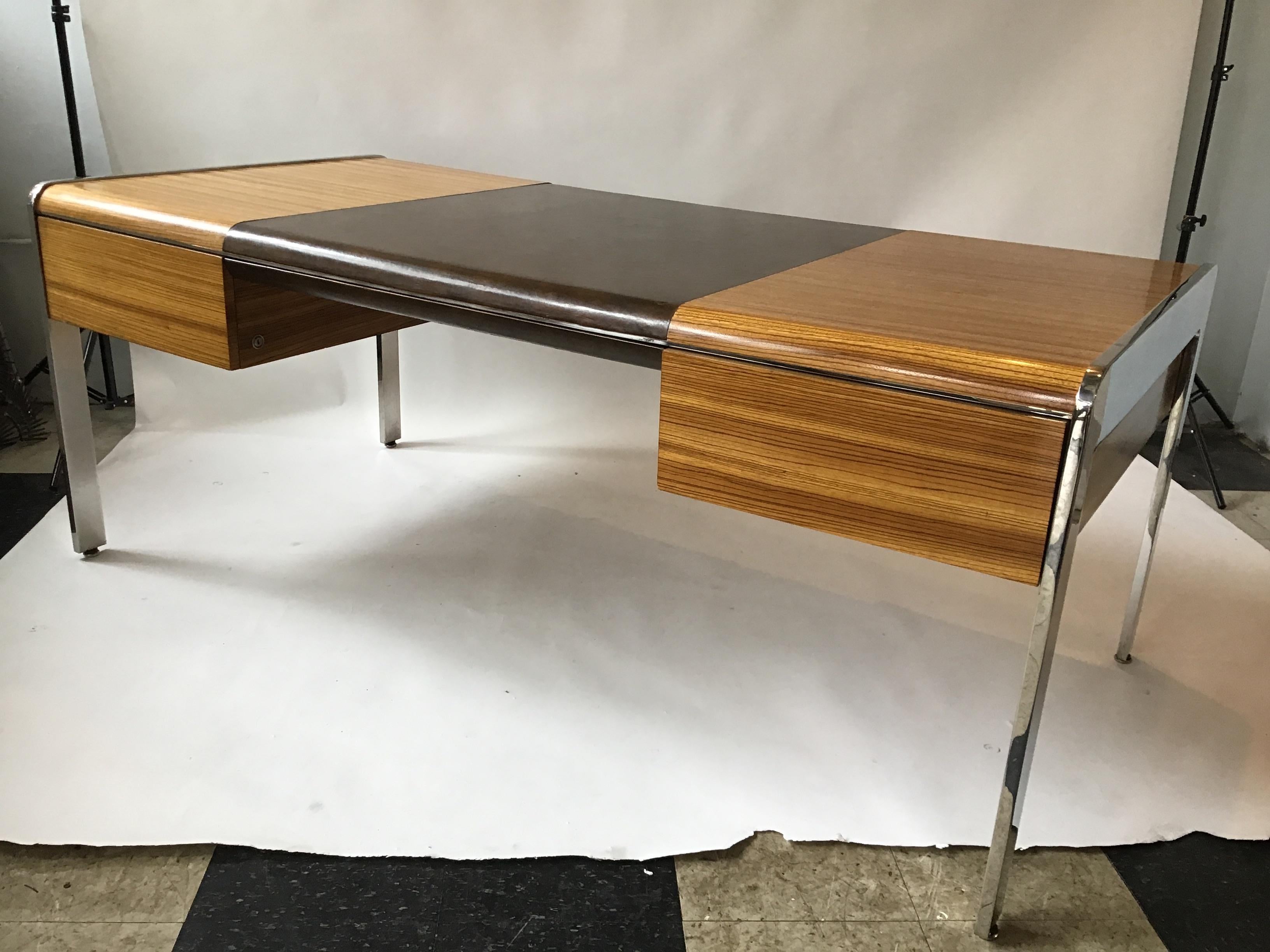 1970s Zebra wood and chrome desk by Leon Rosen for Pace. Leather top. Retractable shelf in back of desk. There are two locks, but no keys.