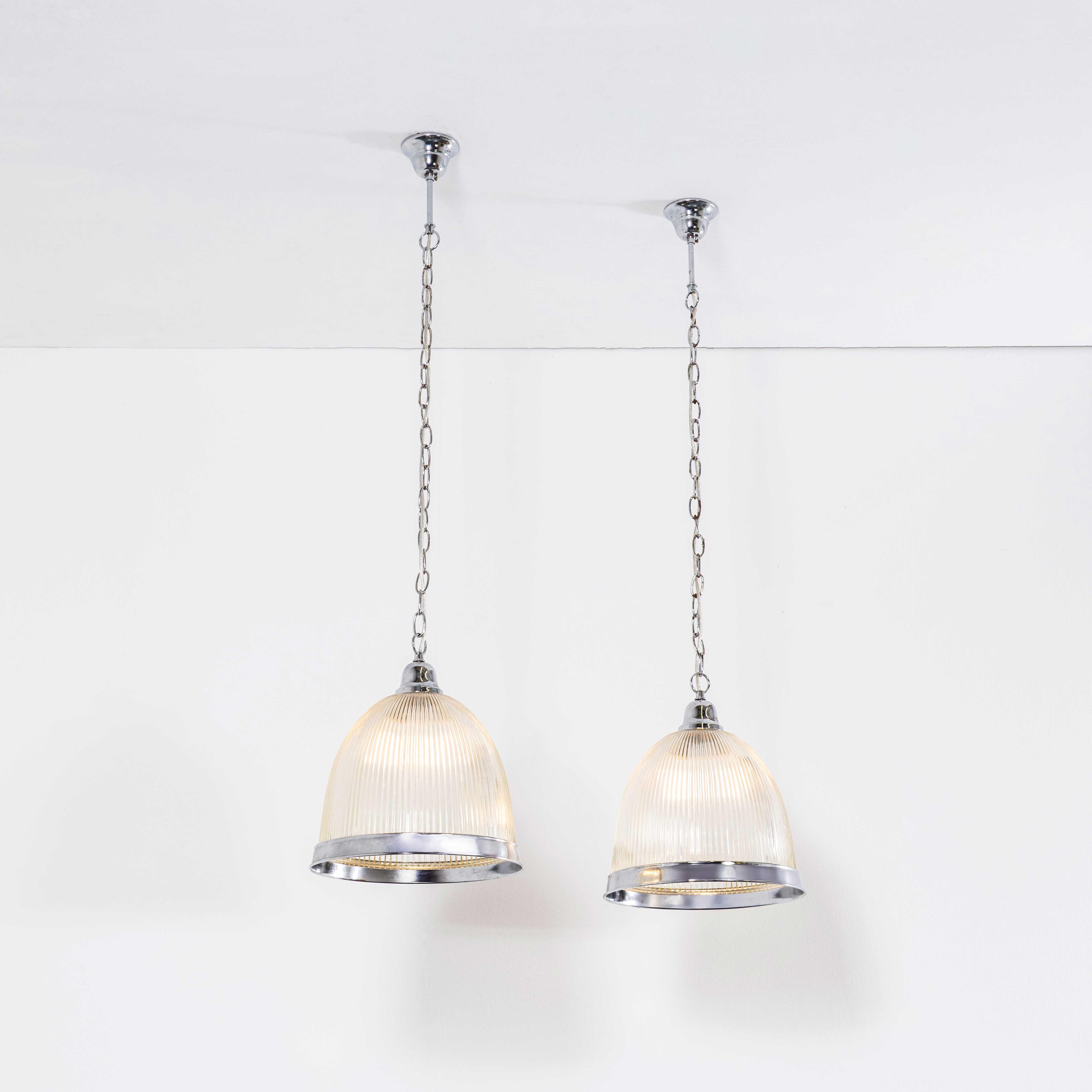 1970’s Late Production Prismatic And Chrome Lamps – Pair. 
In the style of Holophane but not made by Holophane, however the prismatic glass is crisp and well produced. The listing is for the pair of lamps. Each lamp has been cleaned and restored.
