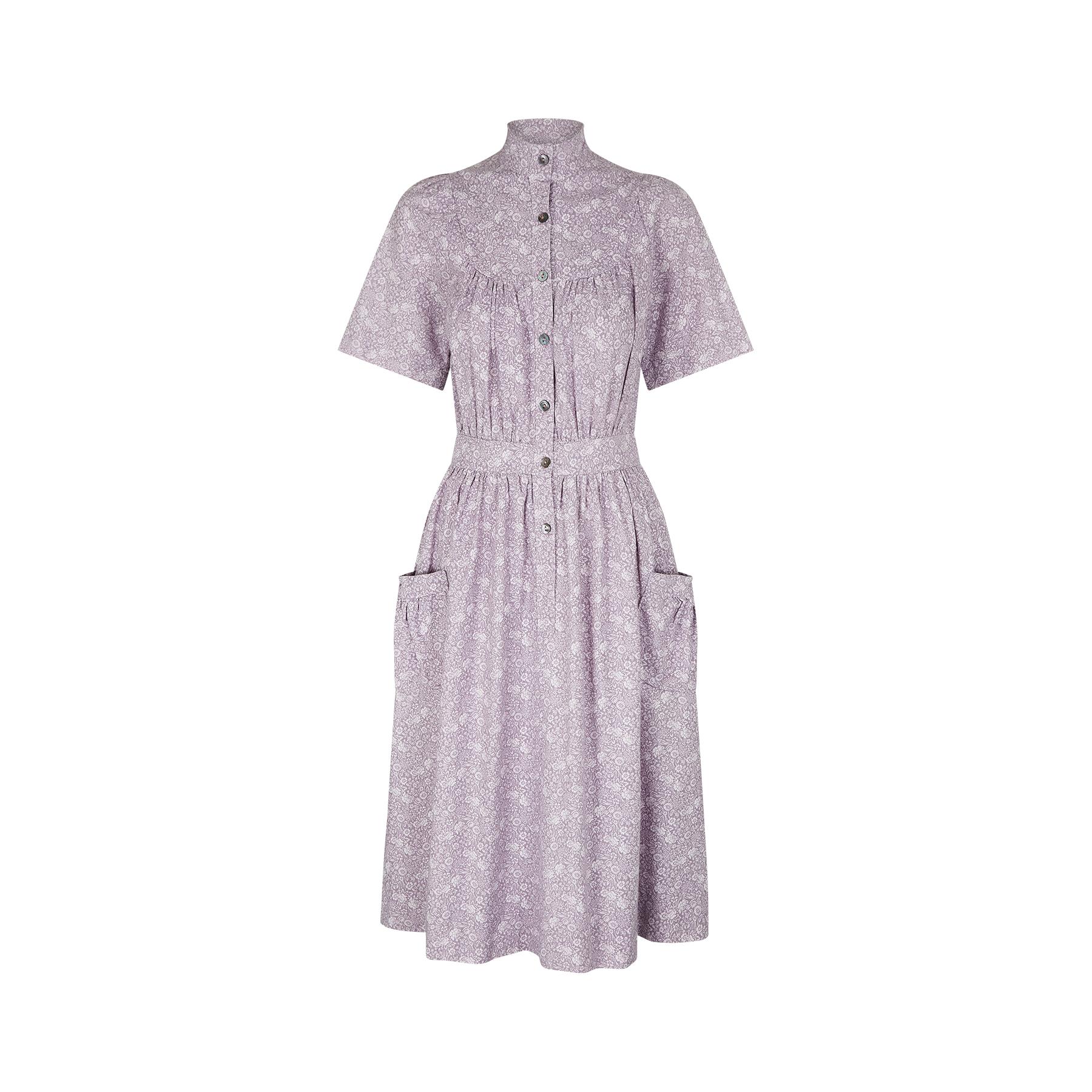 Classic floral cotton shirtwaister dress by Laura Ashley with the early 1970s Made in Wales label. The print has an intricate repeat floral pattern featuring an array of native British flowers including roses, chrysanthemums and pansies in a mauve