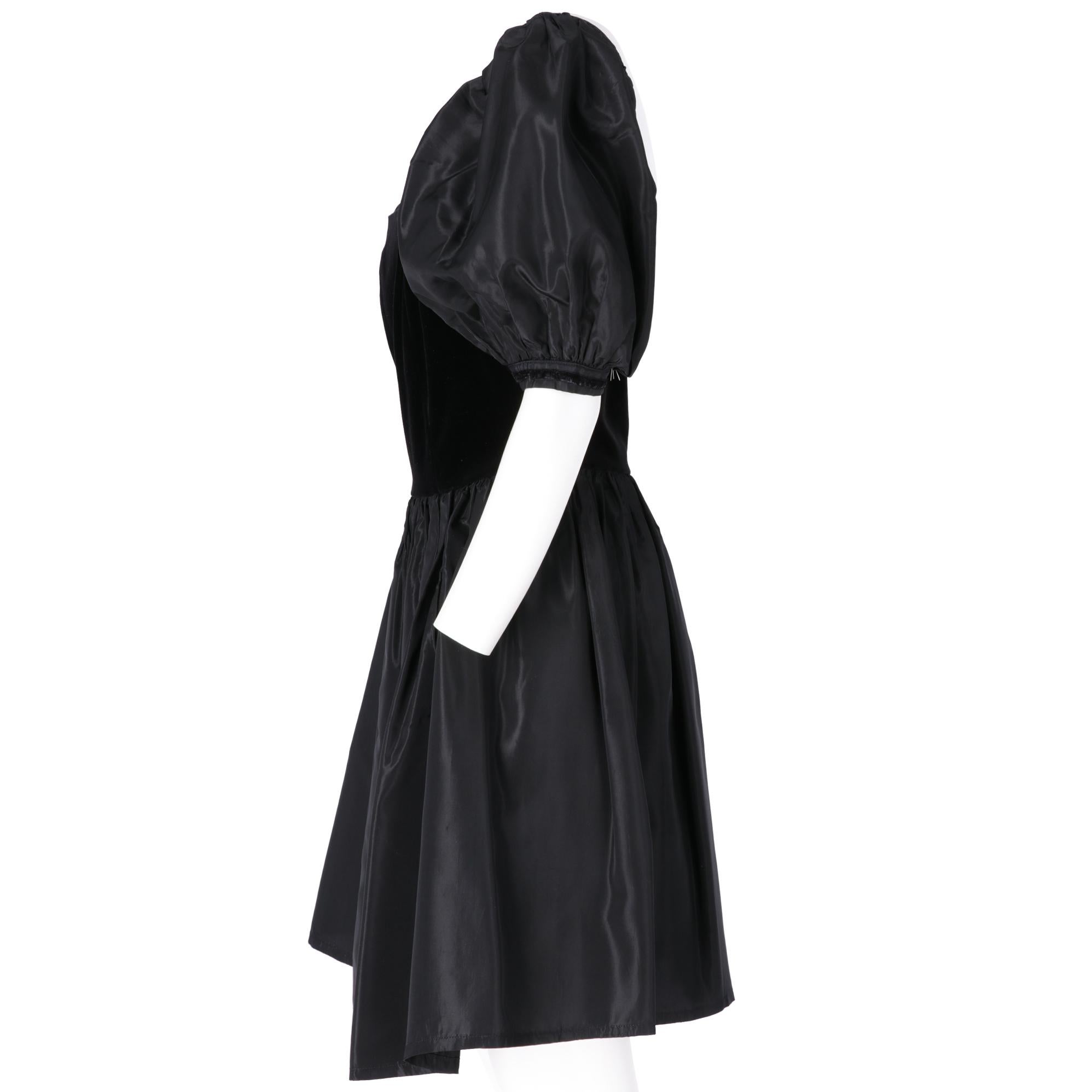 Laura Ashley empire-shaped dress, square neckline, black velvet top with nylon balloon sleeves and skirt of the same fabric with pockets inserted in the seam, back zip closure.

Years: 70s

Made in Rep. of Ireland

Size: 42 IT

Linear
