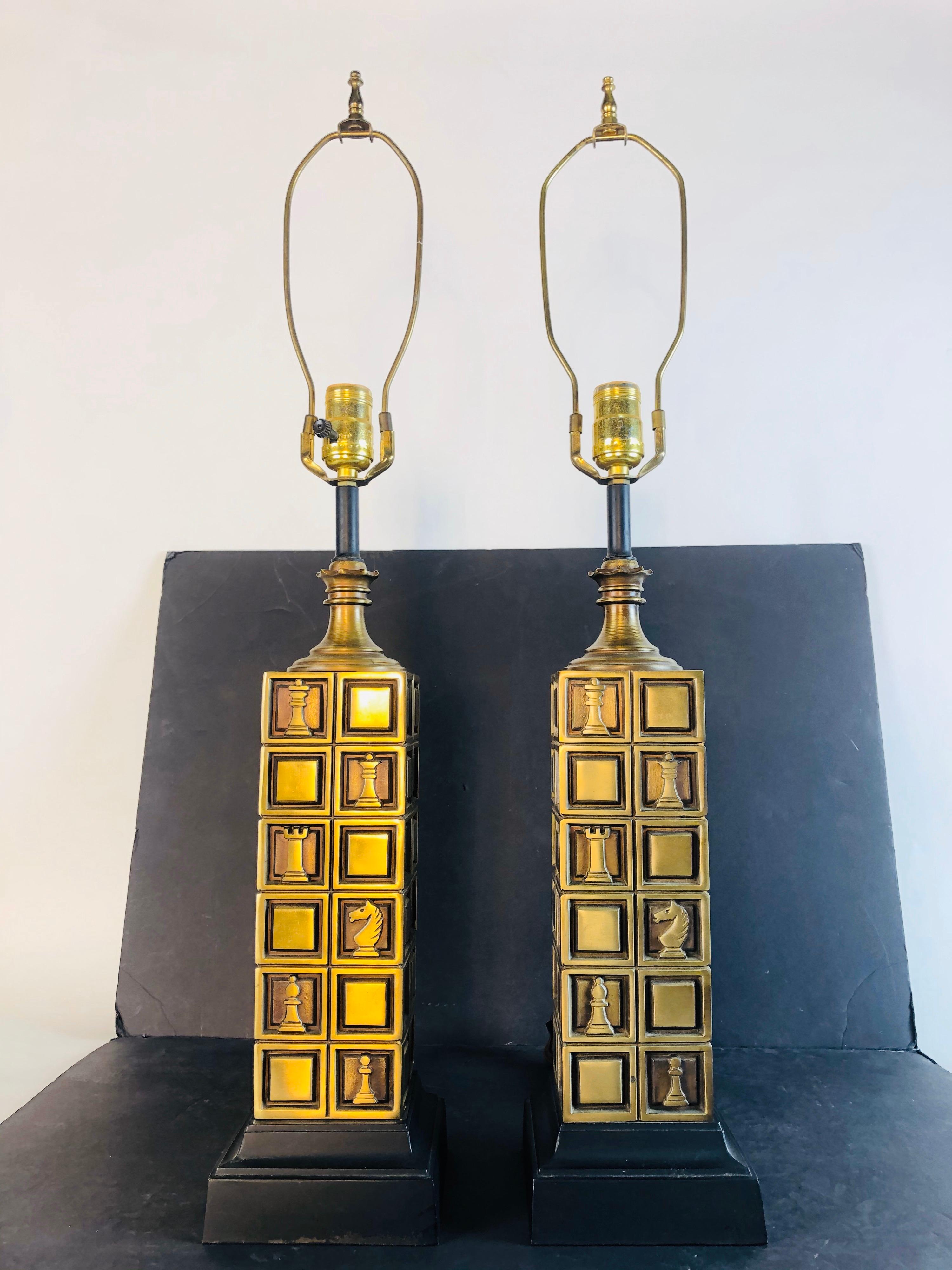 1970s pair of brass chess lamps designed by Laurel Lamp Co. the square lamps have a black metal base. The lamps have different chess pieces on the base. Wired for the US and in working condition. Socket, 20.75” height. Harp, 4” diameter x 9” height.