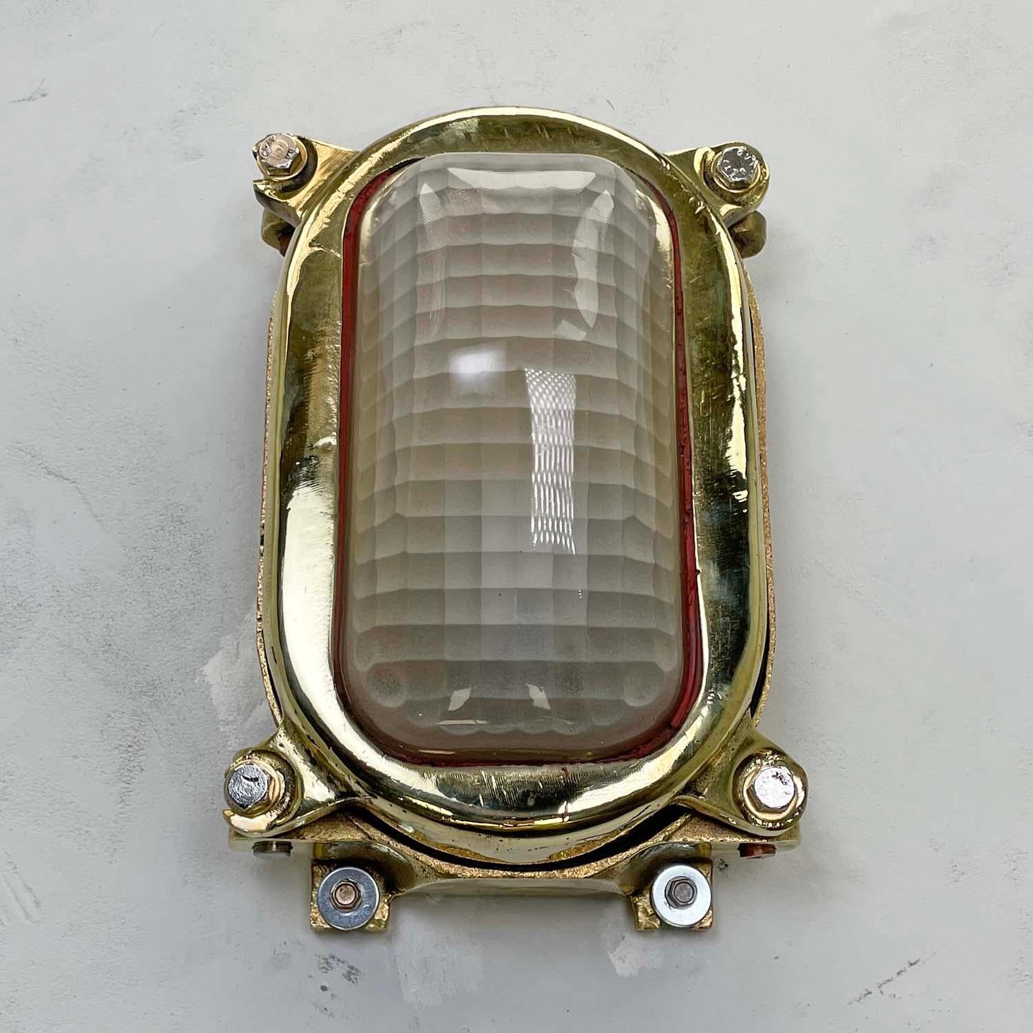 These vintage cast brass rectangular wall lights feature a decorative frosted quadrant pattern diffusion glass shade making these industrial bulkhead fixtures highly distinctive. 

Reclaimed from 1970's cargo ships, professionally restored by