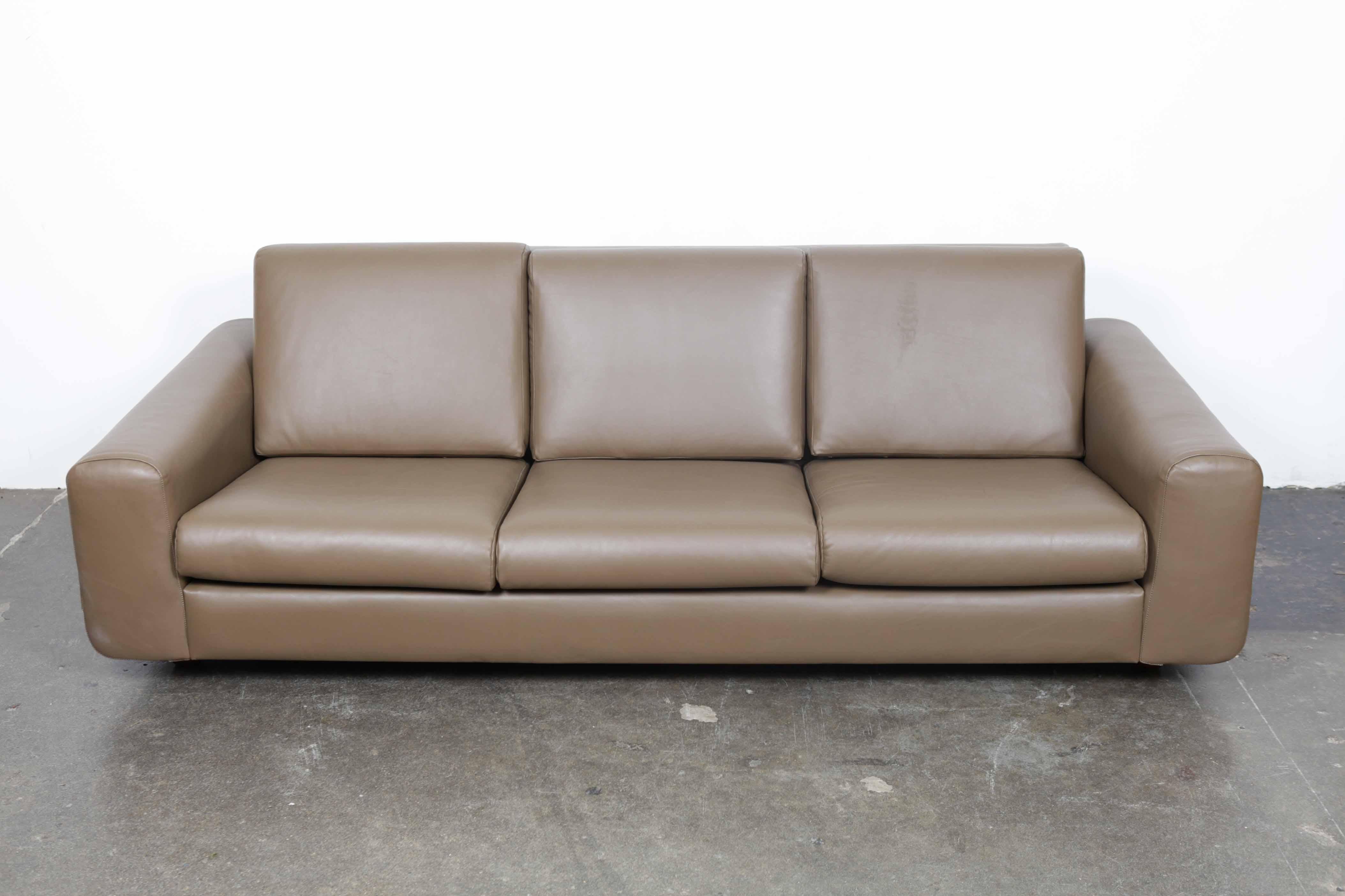 Brazilian 1970s 3-seat sofa with bent rosewood curved side frame, loose cushions and low profile. Newly upholstered in a soft grey toned leather. Rosewood has been refinished.