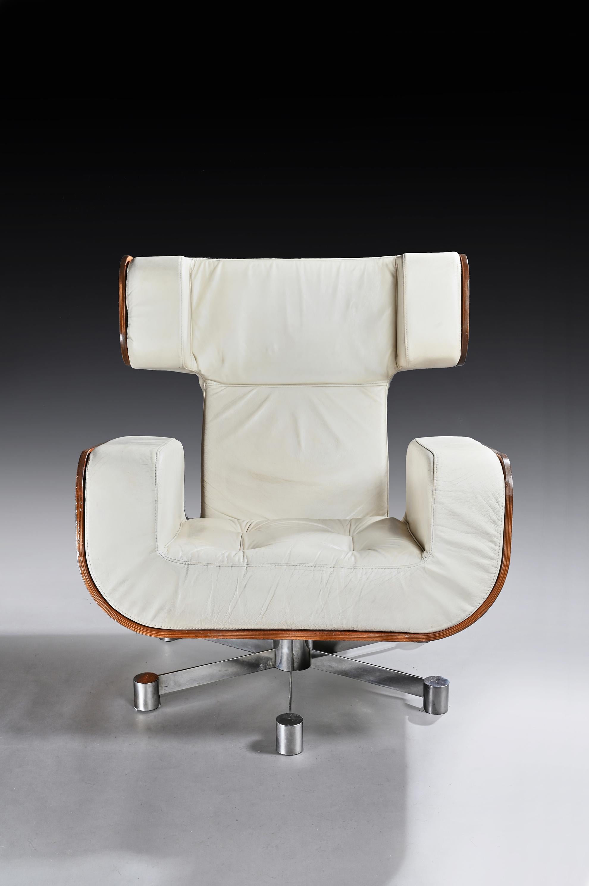 A large 1970s leather and Zebrano longe armchair on splayed chrome base.

Possibly, Italian, 1970s.

The ivory leather covered back and U-shaped shallow buttoned cushion seat and arms, enclosed by a laminated Zebrano wood shell back on an