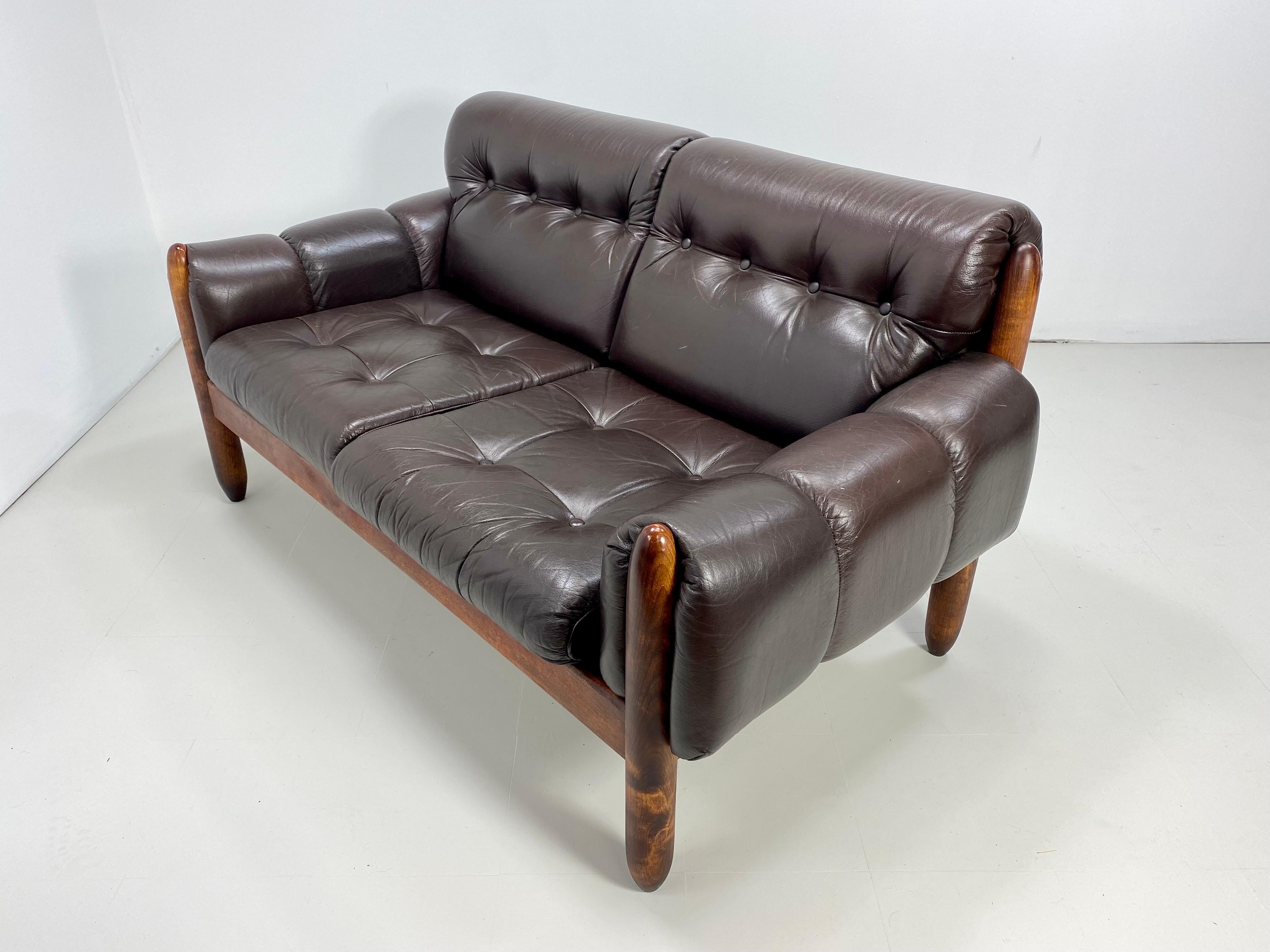 1970s Brazilian Leather Sofa /Settee. Wood frame with button tufted dark brown leather upholstery.


