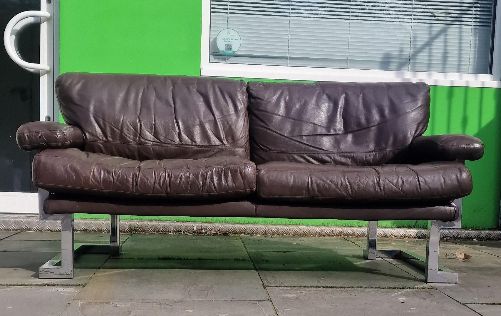 Wonderfully designed leather 2 seater sofa 
From the Mandarin Collection in soft dark brown leather  geometric chrome frame designed by Tim Bates 
For Pieff Furniture Cc 1970 