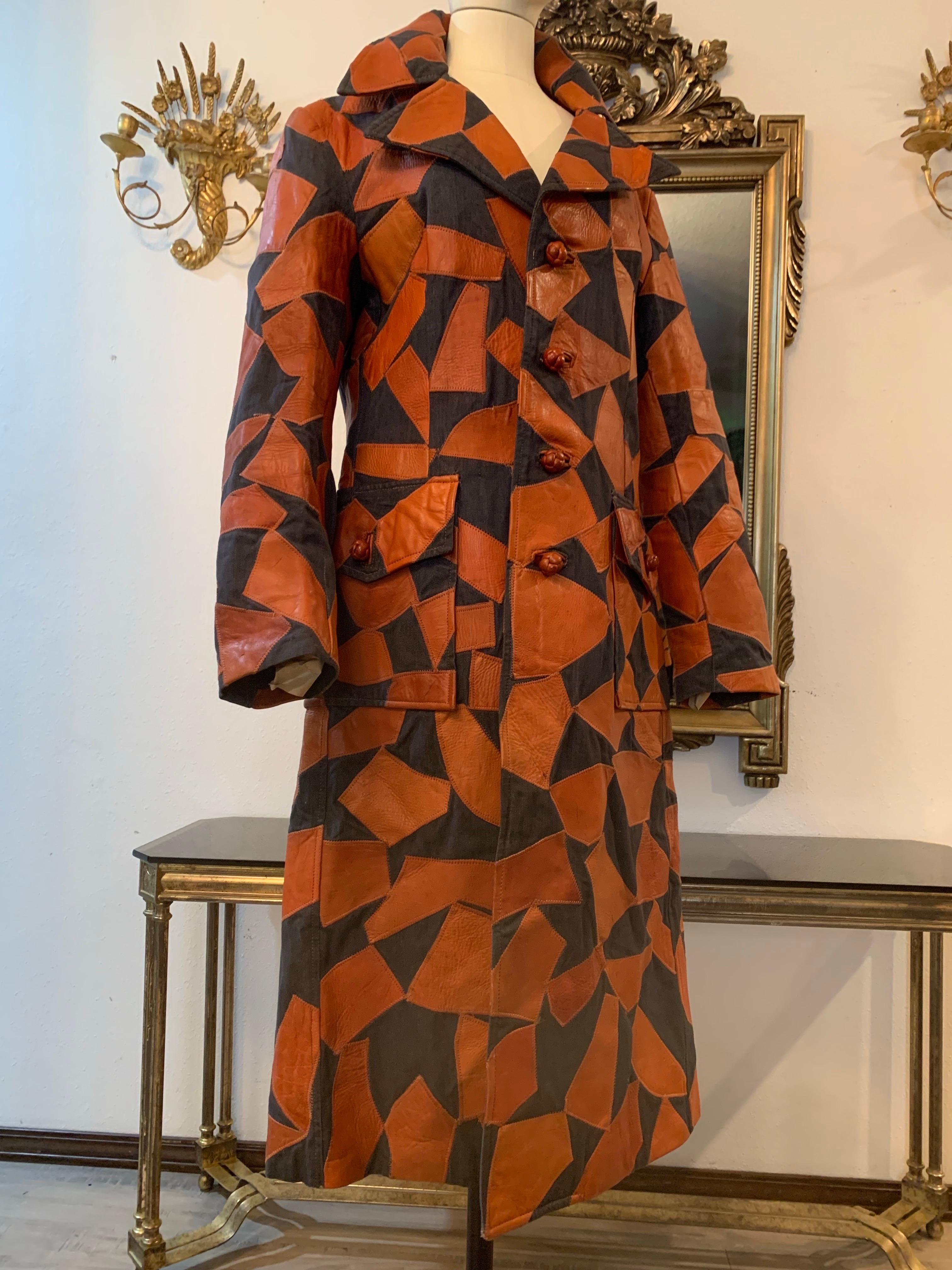 1970s Lee Imports Super-Fly Patchwork Denim & Cognac Leather Trench Coat: Pouch pockets, deep back vent, fully lined. Notched collar and knotted leather buttons at front, cuffs and pockets. Marked Men's Size 40 Regular.