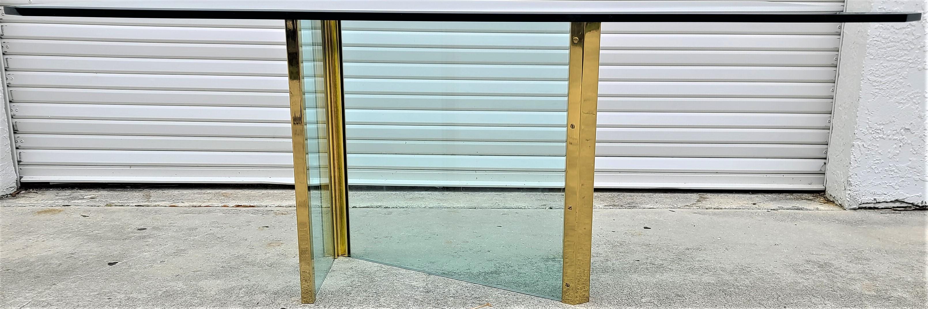 Offering one of our recent Palm Beach Estate fine furniture acquisitions of a
1970's Leon Rosen for Pace Collection glass & brass dining table

Approximate measurements in inches
Table with base:
28.75