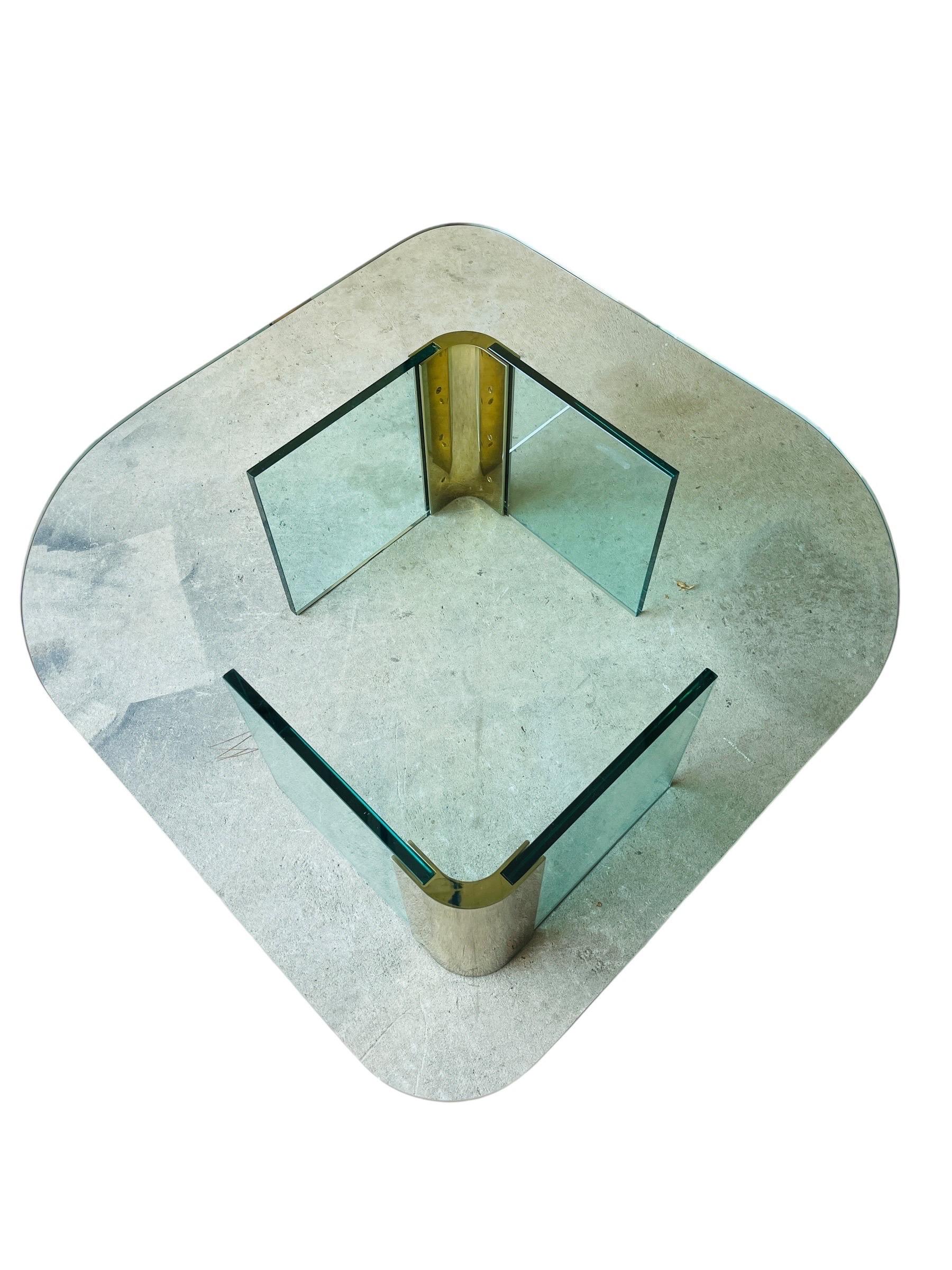 This stunning Pace Collection Post-Modern Coffee Table, designed by Leon Rosen, combines a minimalist aesthetic with the elegance of glass and brass. Manufactured in the 1970s, this table features a unique navette-shaped glass top with beveled