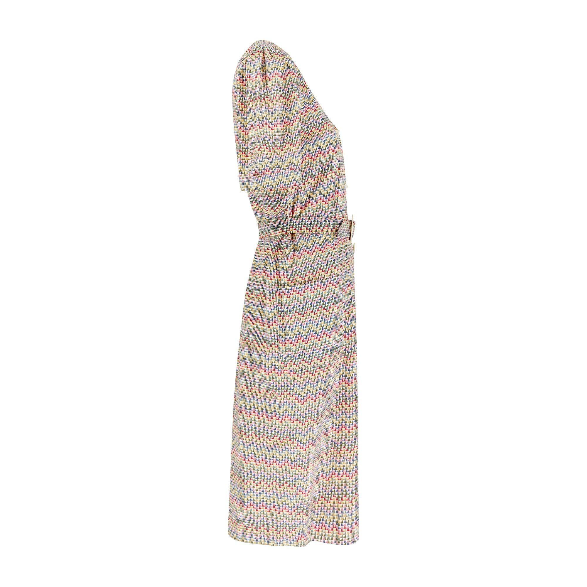 This unusual dress was designed by iconic London department store Liberty during the early 1970s. Tailored from the brand’s signature Tana Lawn soft cotton, it is printed with a repetitive print of tiny Isosceles triangles in rainbow hues. It has an