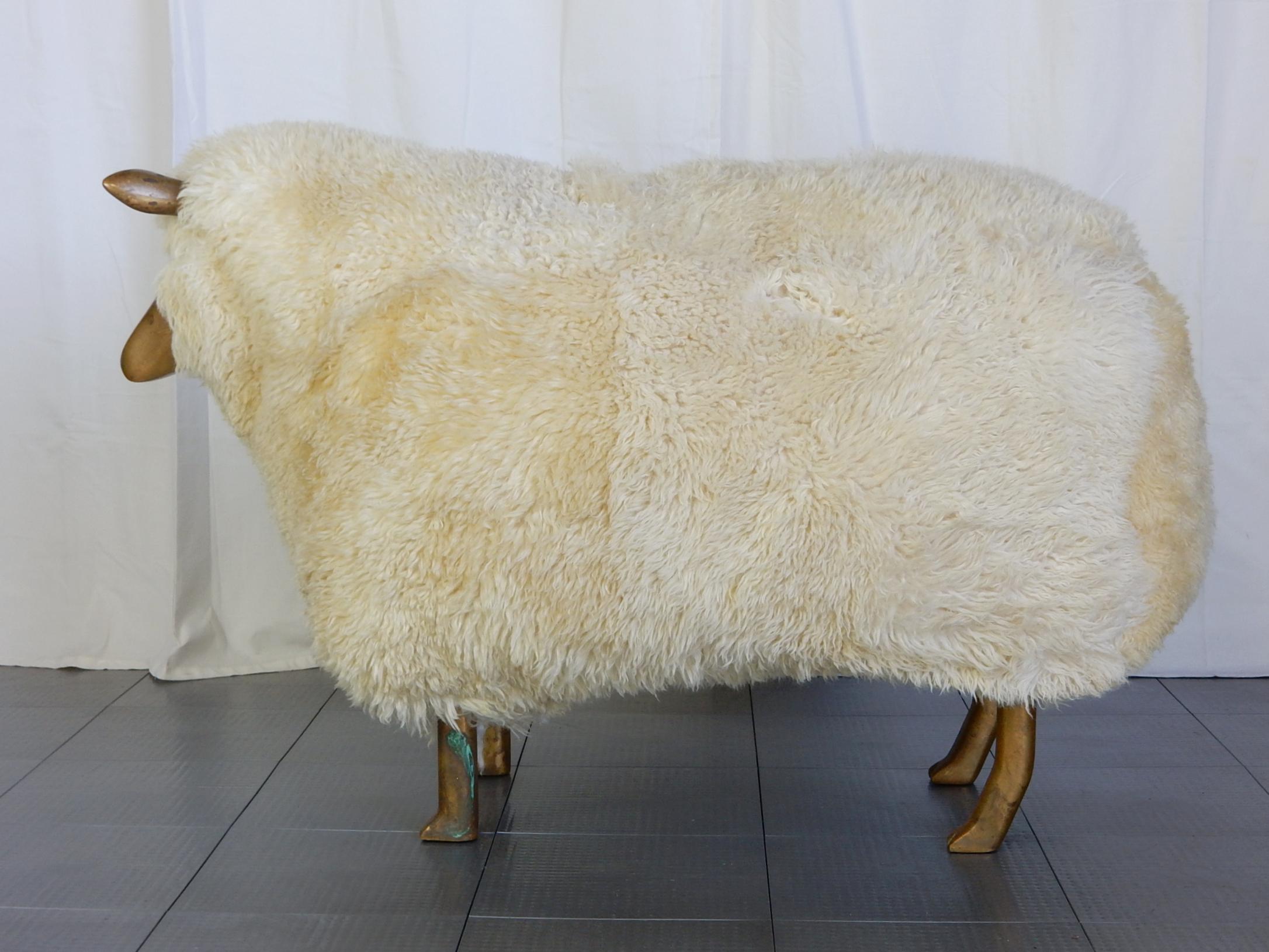 In the manner of Claude and Francois-Xavier Lalanne this life-size sheep ottoman
with solid brass legs, face and ears is circa 1970s (judging by the aged brass patina).
Thick plush real sheepskin upholstered over a foam covered wooden frame.
A