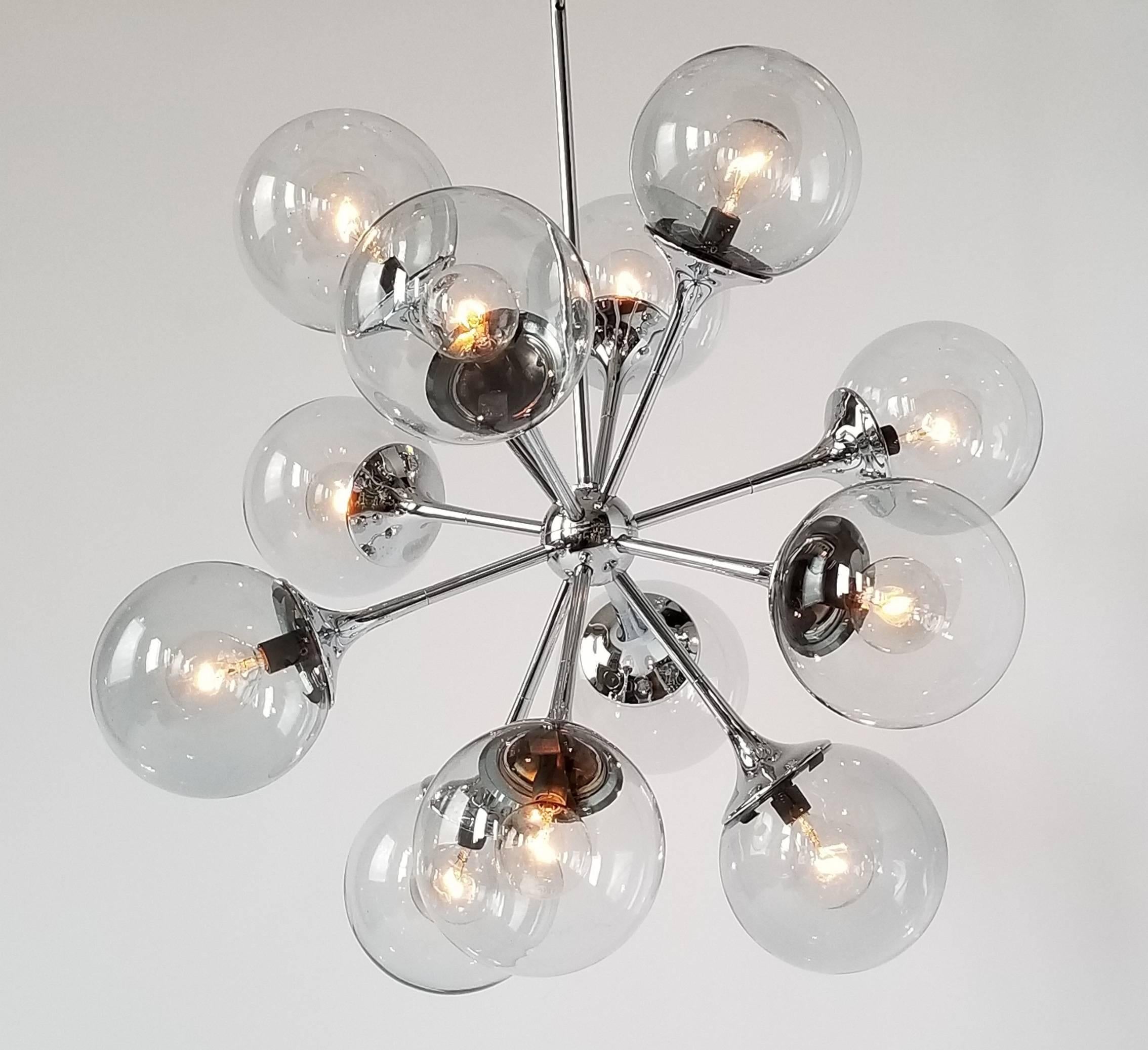 1970s deep chrome finish chandelier with mouth blowed glass shade. 

Well made solid construction. 

Contain 12 E12 candelabra size socket rated at 40 watt max. 

Sputnik measure 23 X 23 in. Total lenght with chain and canopy 31 in. 

Signed item.