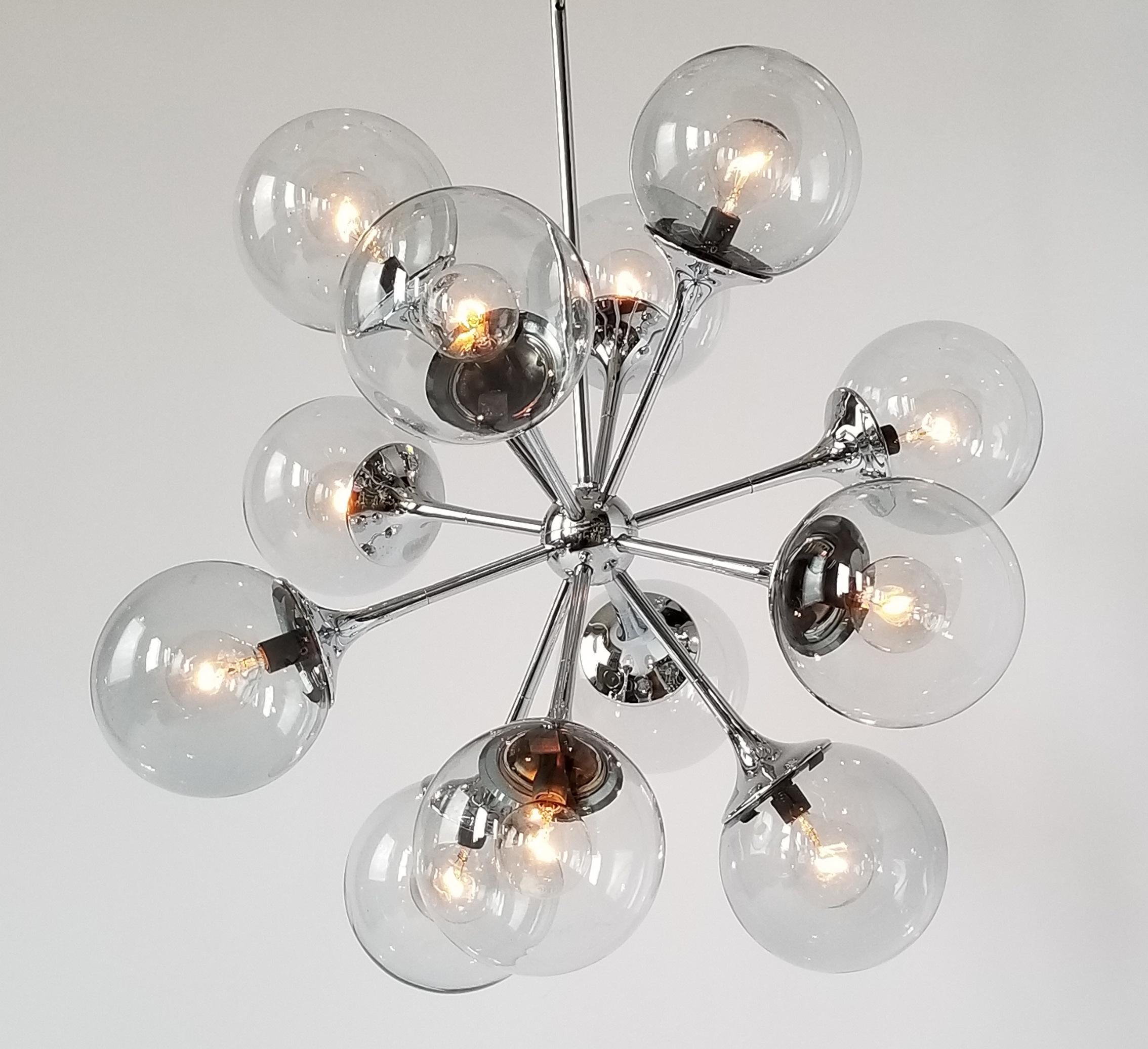 Deep chrome finish chandelier with mouth blowed glass shade, 1970s

Well made solid sturdy construction. 

Contain 12 E12 candelabra size socket rated at 40 watt max. 

Sputnik measure 23 X 23 in. Total length with chain and canopy 34 in. 

