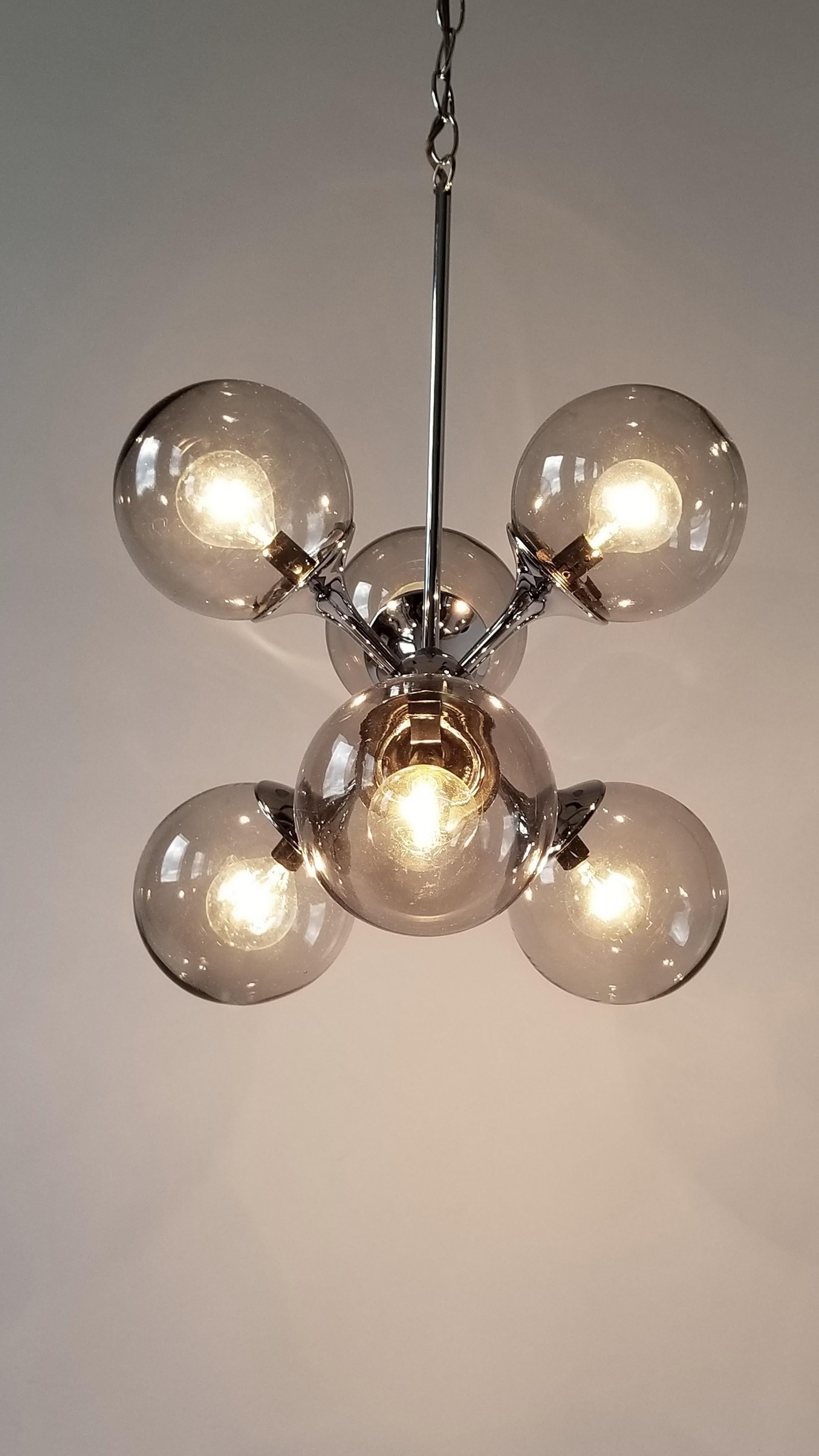 Six mouth blowed glass shade sitting on a deep chrome finish structure from Lightolier. 

Each shade measure 5 in. diameter. 

Solid, well made construction. 

Use six candelabra E12 size lightbulb rated at 40 watt max. 

Chain length is 18