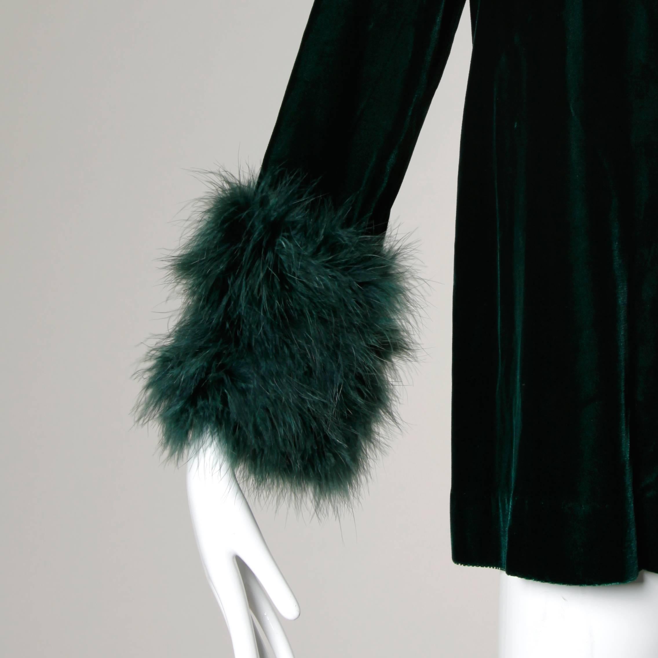 Vintage 1970s dark green velvet swing jacket with marabou feather cuffs. Fully lined with front snap closure. The marked size is 12, but the jacket fits more like a modern size small-medium. The measurements are as follows: Bust: 40