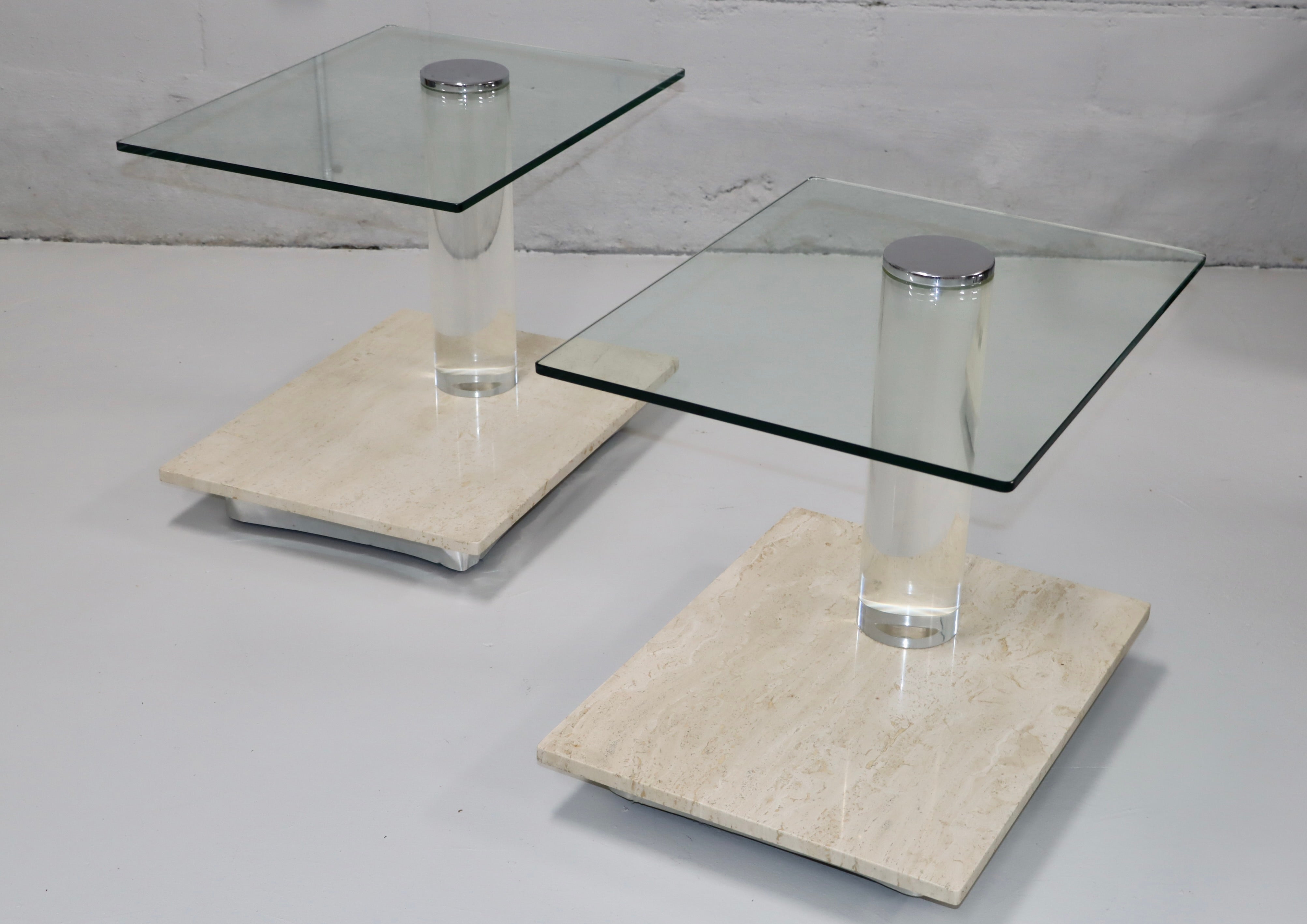 Amazing pair of 1970's modern Lion In Frost travertine lucite and swivel glass top side tables on casters, both tables are signed in vintage original condition with some wear and patina due to age and use, there is a few chips to the travertine