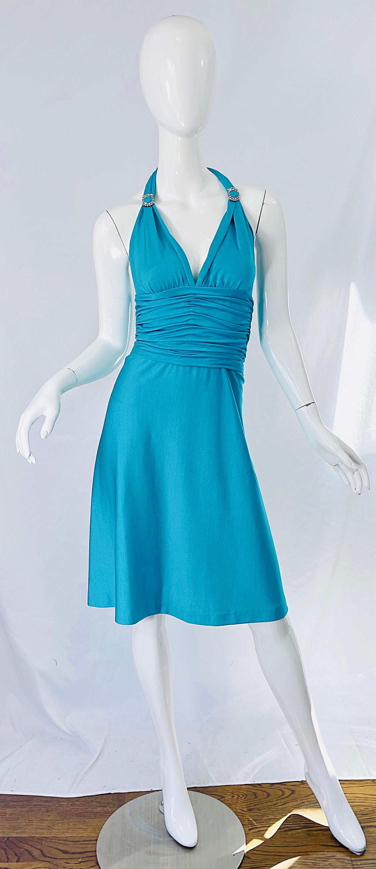 Sexy mid 70s LORIS AZZARO Couture turquoise blue silk jersey rhinestone encrusted halter dress ! The most beautiful jewel tone turquoise blue is flattering on any skin tone. Features a tailored bodice with ruched waist. Rhinestone buckles at each