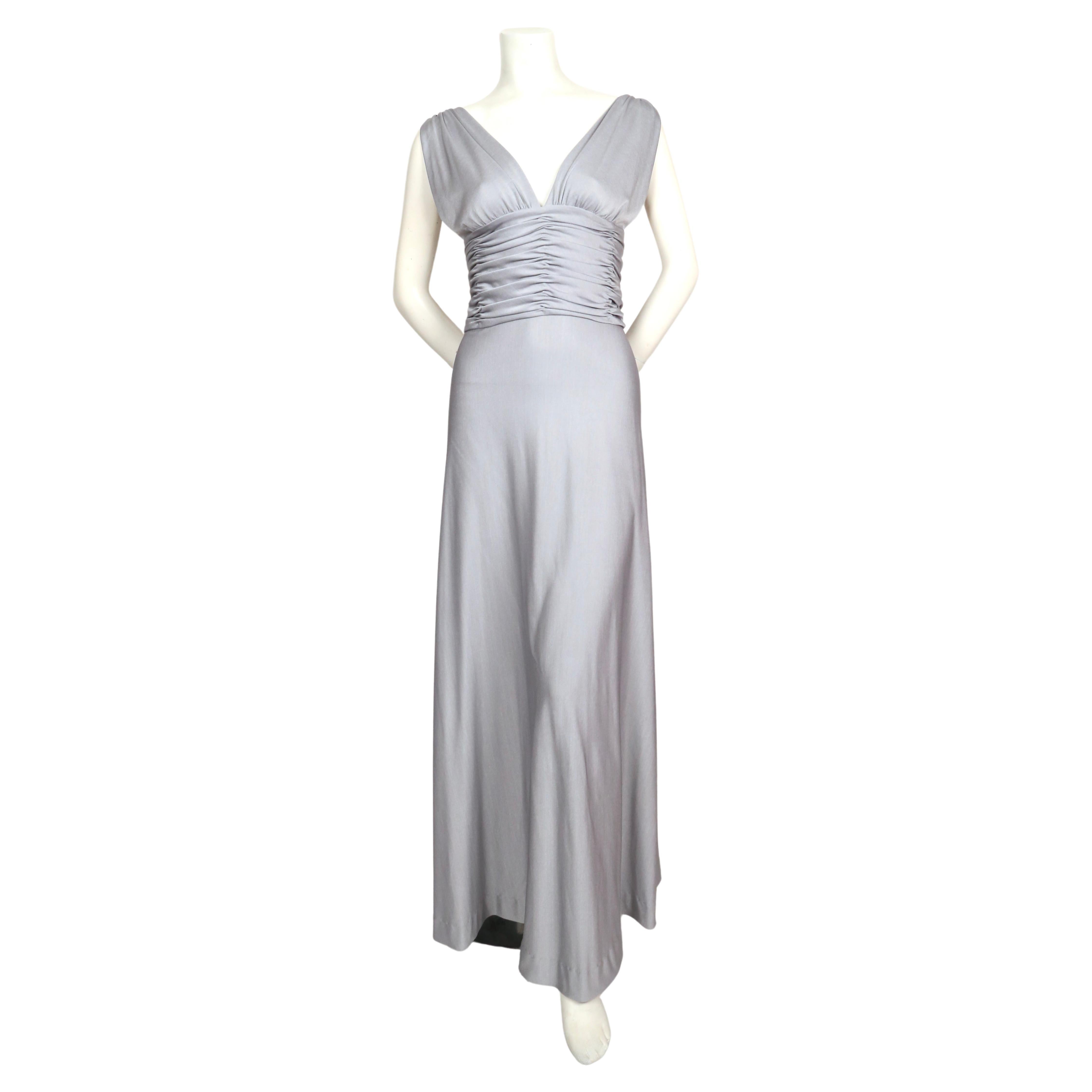 Stunning icy silver blue jersey gown with ruching from Loris Azzaro dating to the 1970's. Dress best fits a size 2-4. Approximate measurements:  32-34