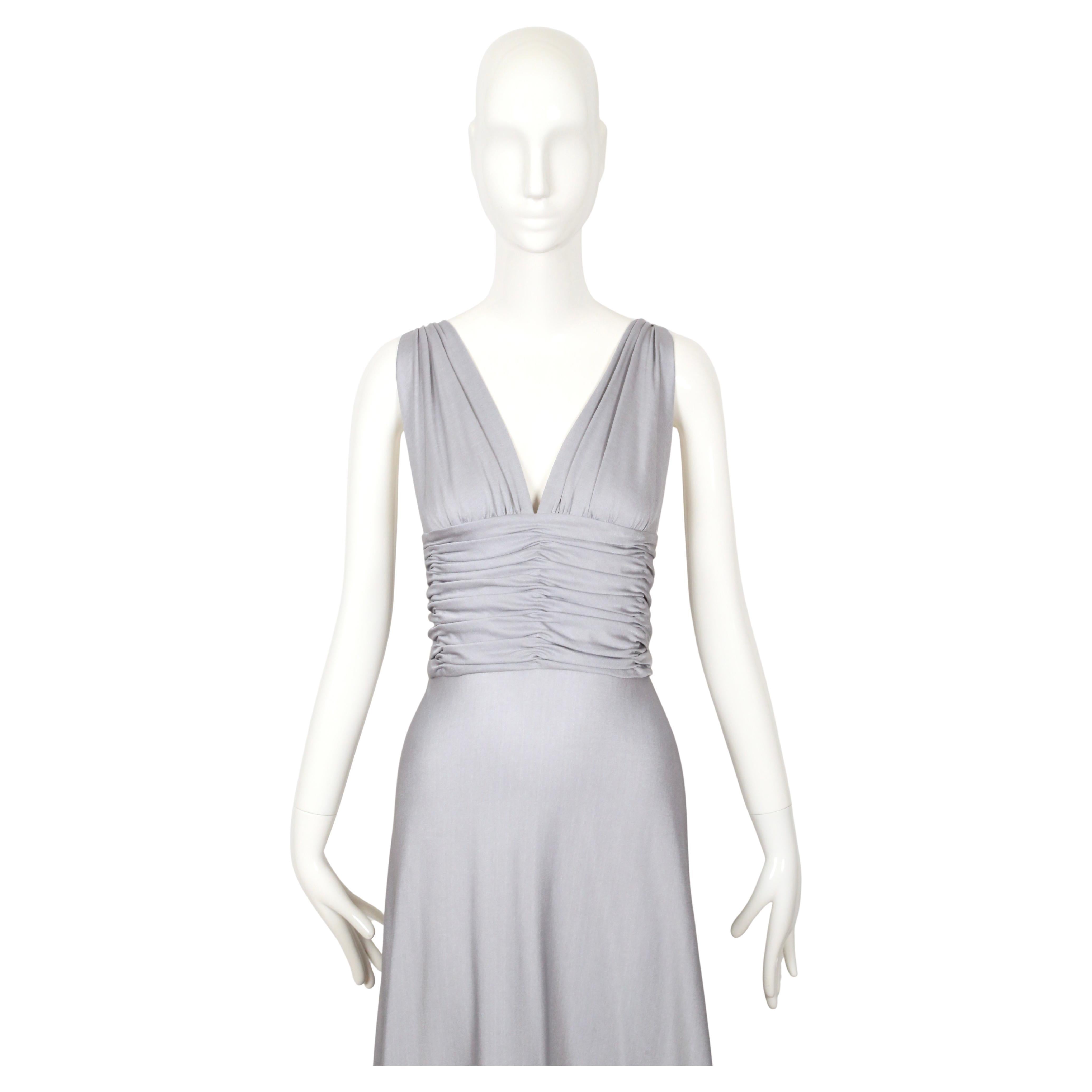 Stunning silver jersey gown with ruching from Loris Azzaro dating to the 1970's. Silver color has a hint of blue in it. Dress best fits a size 2-4 or possibly a 6 with a slim ribcage and waist. Approximate measurements:  bust is open, under bust