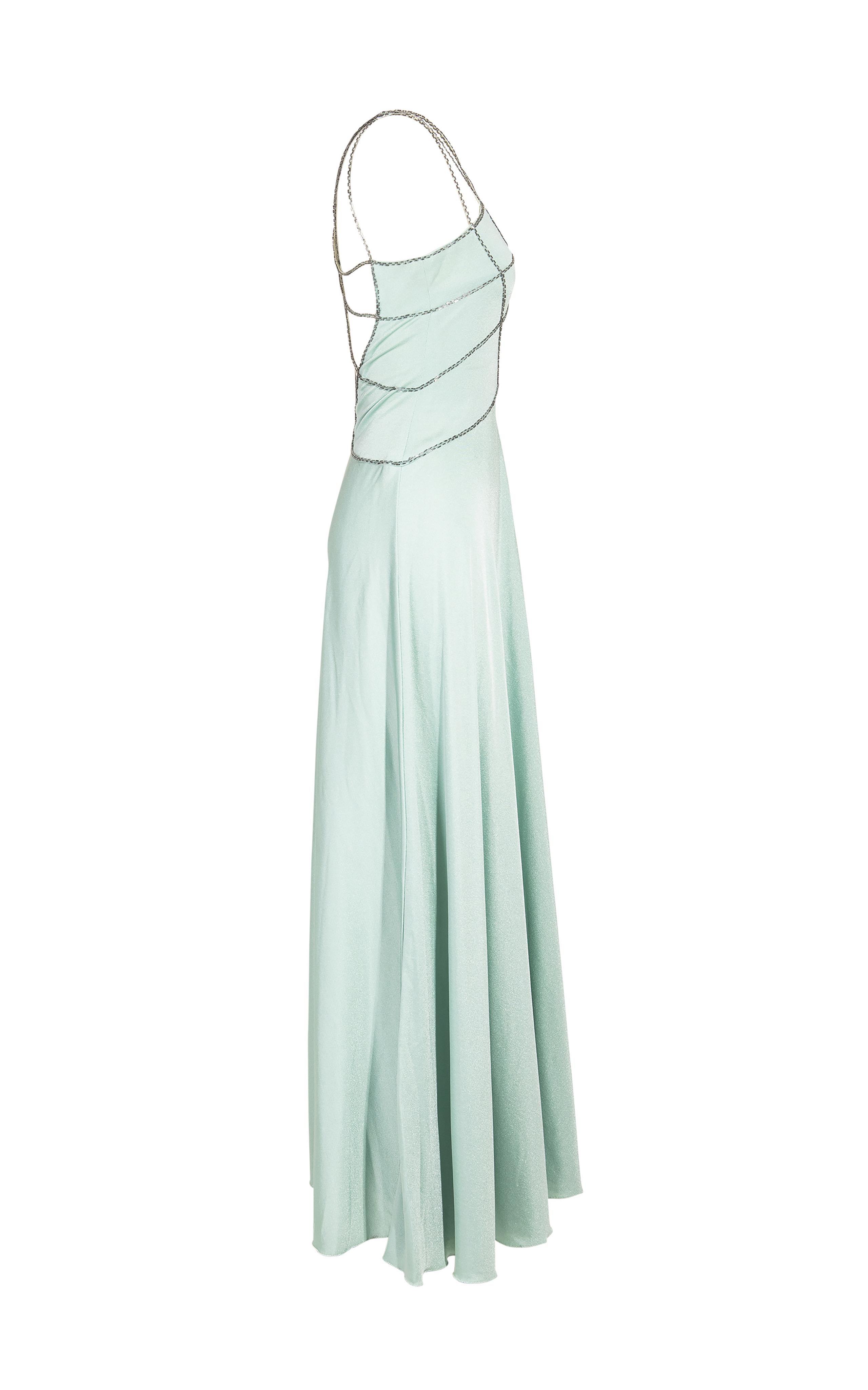 1970's Loris Azzaro mint gown with beaded cage upper. Beaded cage detail wraps across chest and back. Full length sleeveless gown with full skirt and moderate stretch throughout.