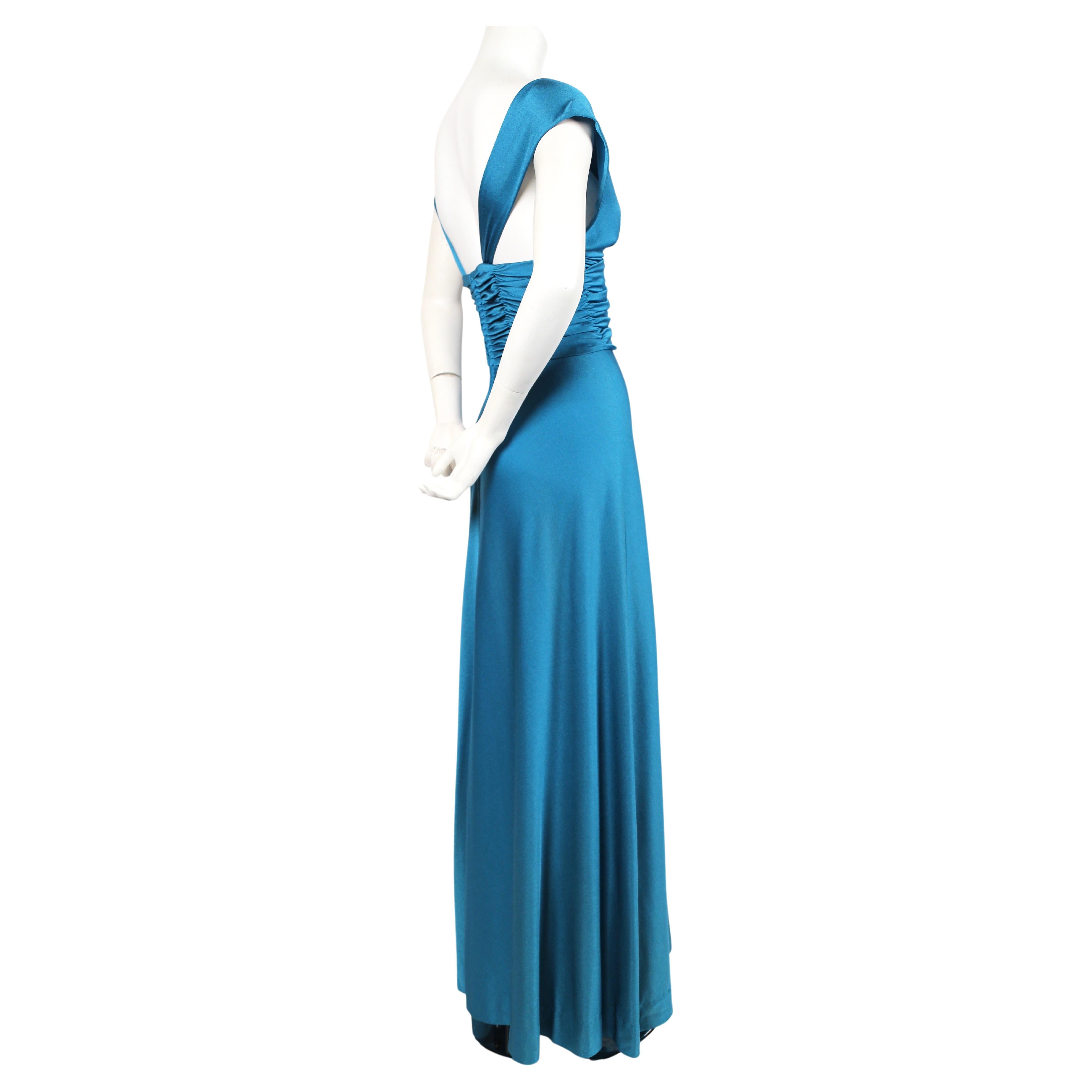 Stunning vivid turquoise blue jersey gown with ruching from Loris Azzaro dating to the 1970's. Dress best fits a size 2-4. Best fits a 32-33