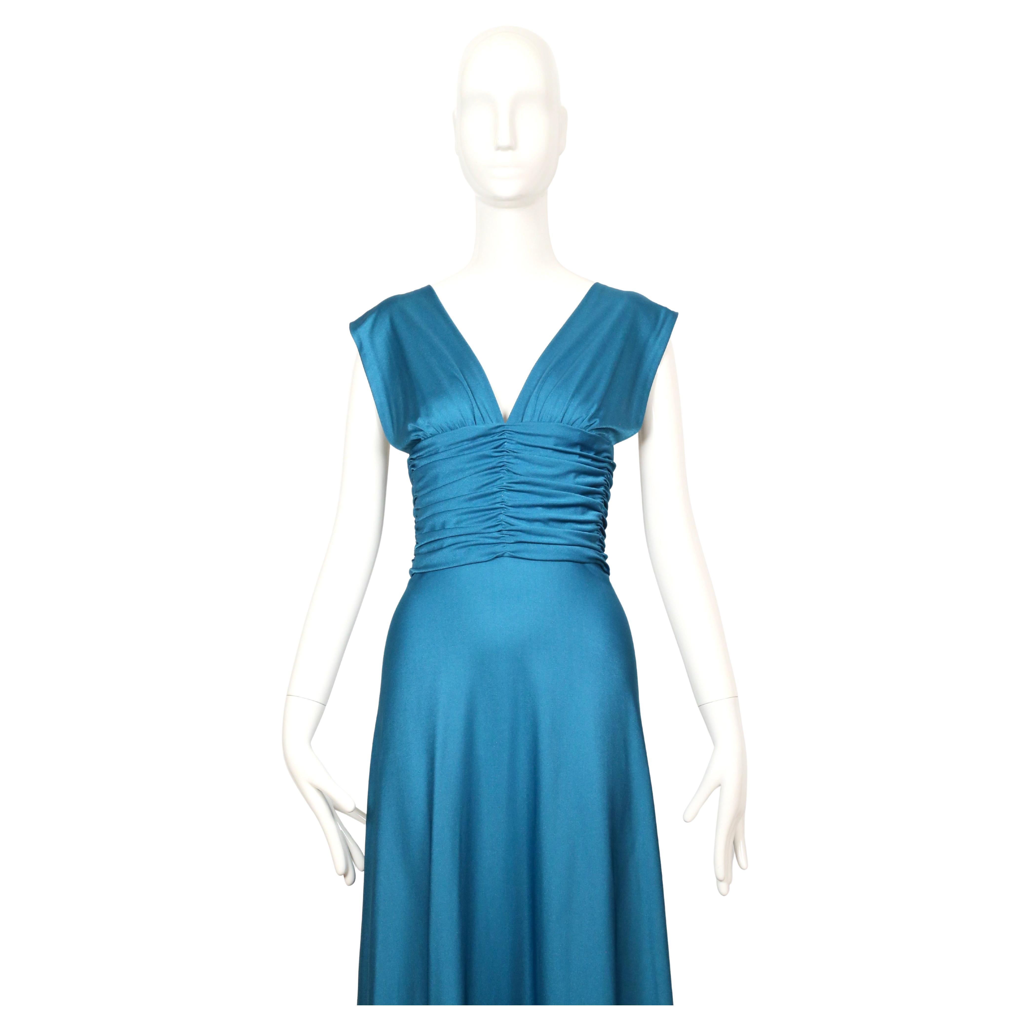 Stunning vivid turquoise blue jersey gown with ruching from Loris Azzaro dating to the 1970's. Dress best fits a size 2-4 or a 6 with a slim ribcage/waist. Approximate measurements:  bust is flexible, under-bust 30