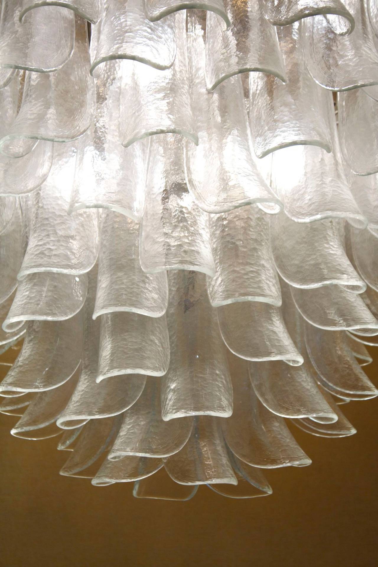 1970s 'Lotus' chandelier by Murano. Cone shape.
Made of Murano glass leaves.
 Wired with twelve bulbs on the structure.