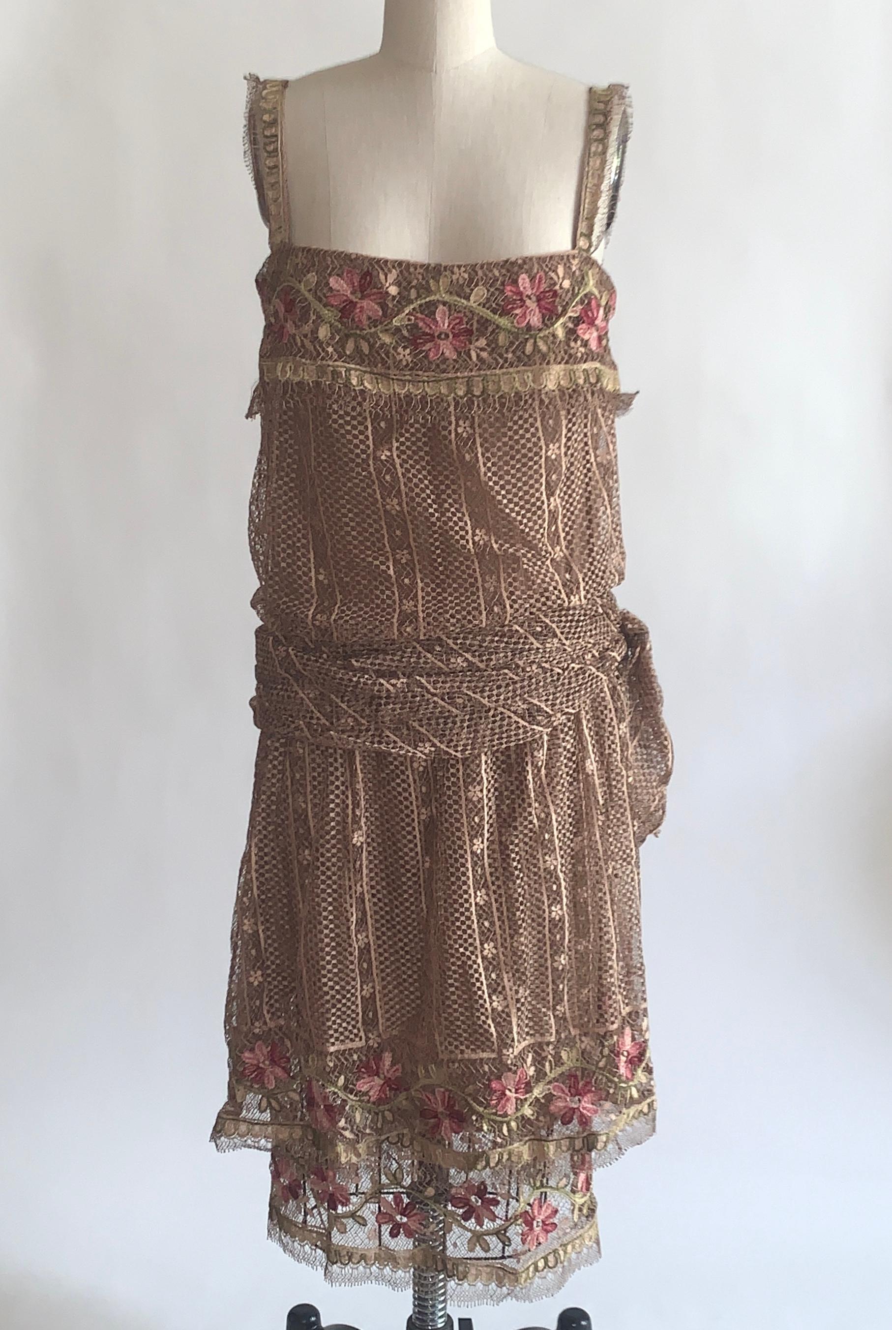 Louis Feraud 1970s haute couture light brown lace dress in a 1920s style drop waist silhouette. Amazing embroidered lace and hand finished seam allowances. Small buttons conceal a back zip.

Lace exterior, fully lined in what feels like silk.

Made