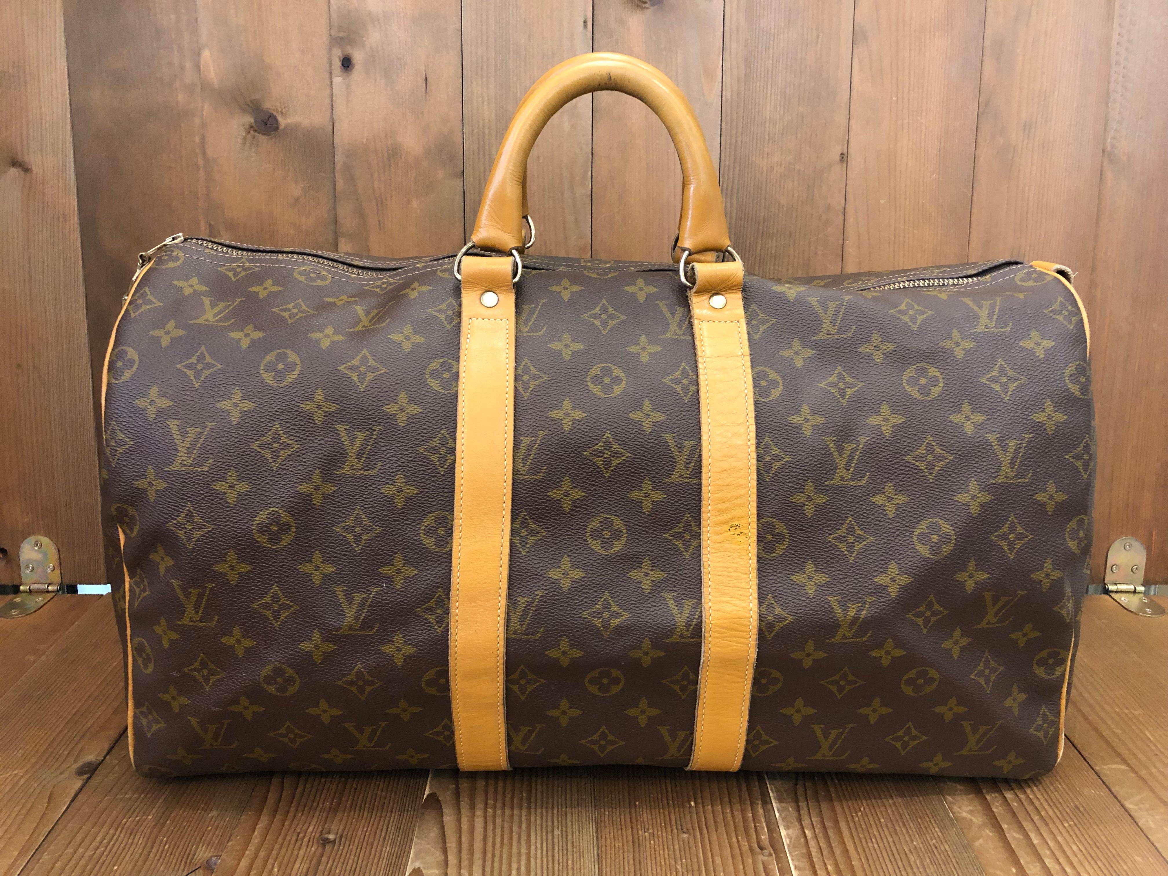 This rare 1970s vintage French Company LOUIS VUITTON Keepall 50 crafted of Louis Vuitton Monogram Canvas trimmed with brown treated leather, unlike the normal LV vachetta leather which ages and darkens with time, this brown leather stays the same