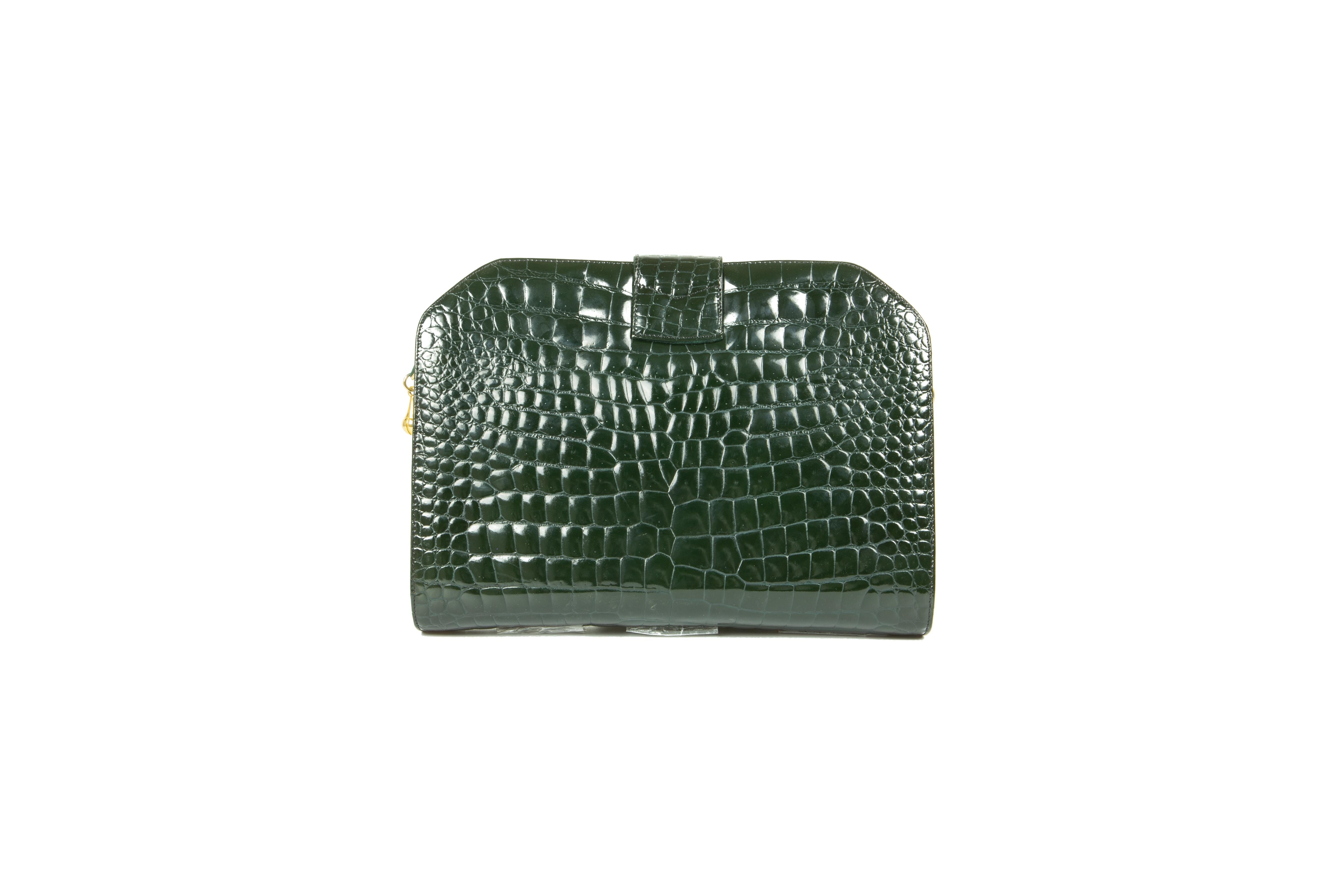 A rare early 1970s Louise Fontaine hunter-green porosus crocodile clutch/shoulder bag, comprising of one compartment with one gusseted zipper pocket, fully lined in black, suspended on an optional self strap - the reverse in forest-green leather -