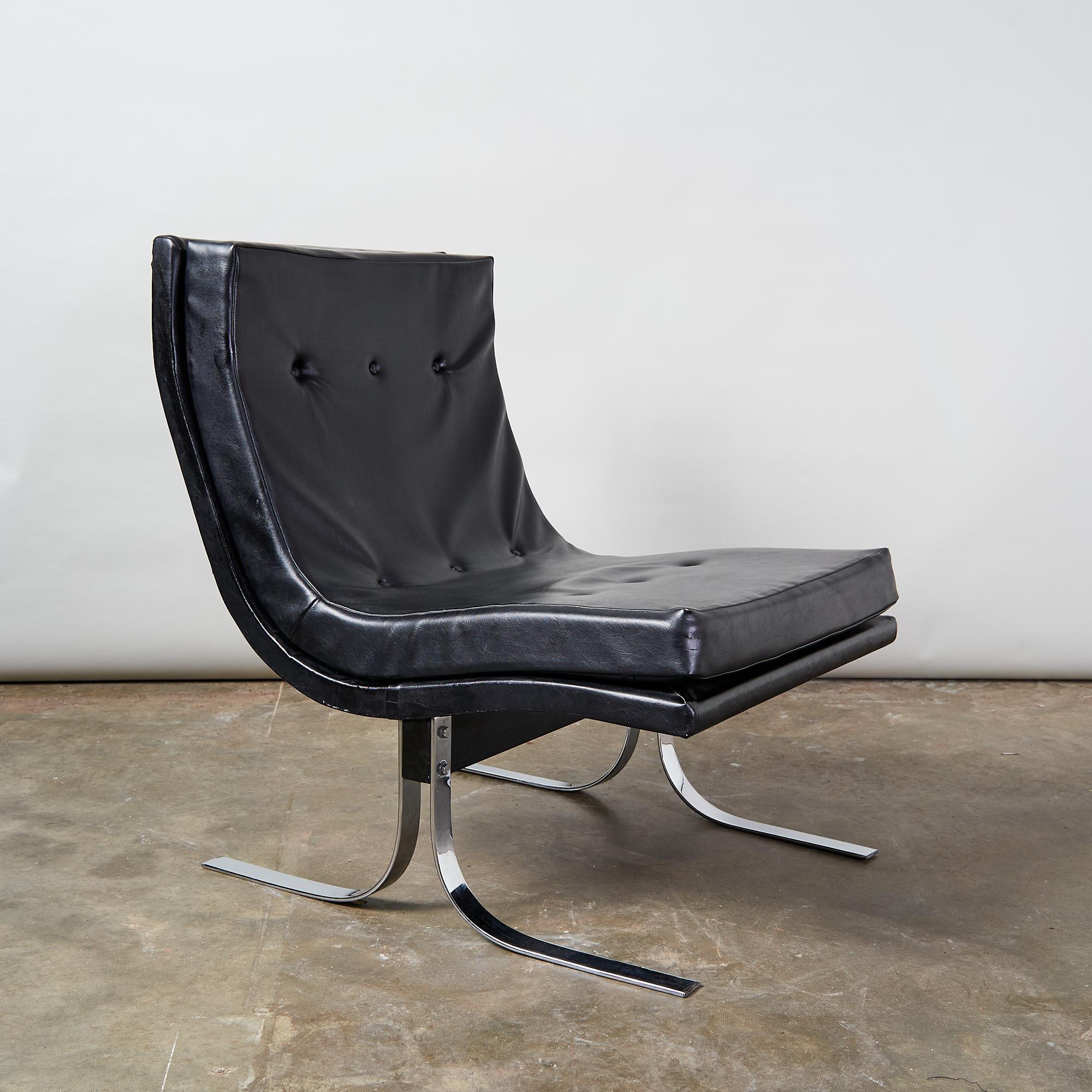 A 1970s leatherette lounge chair with chrome feet.
