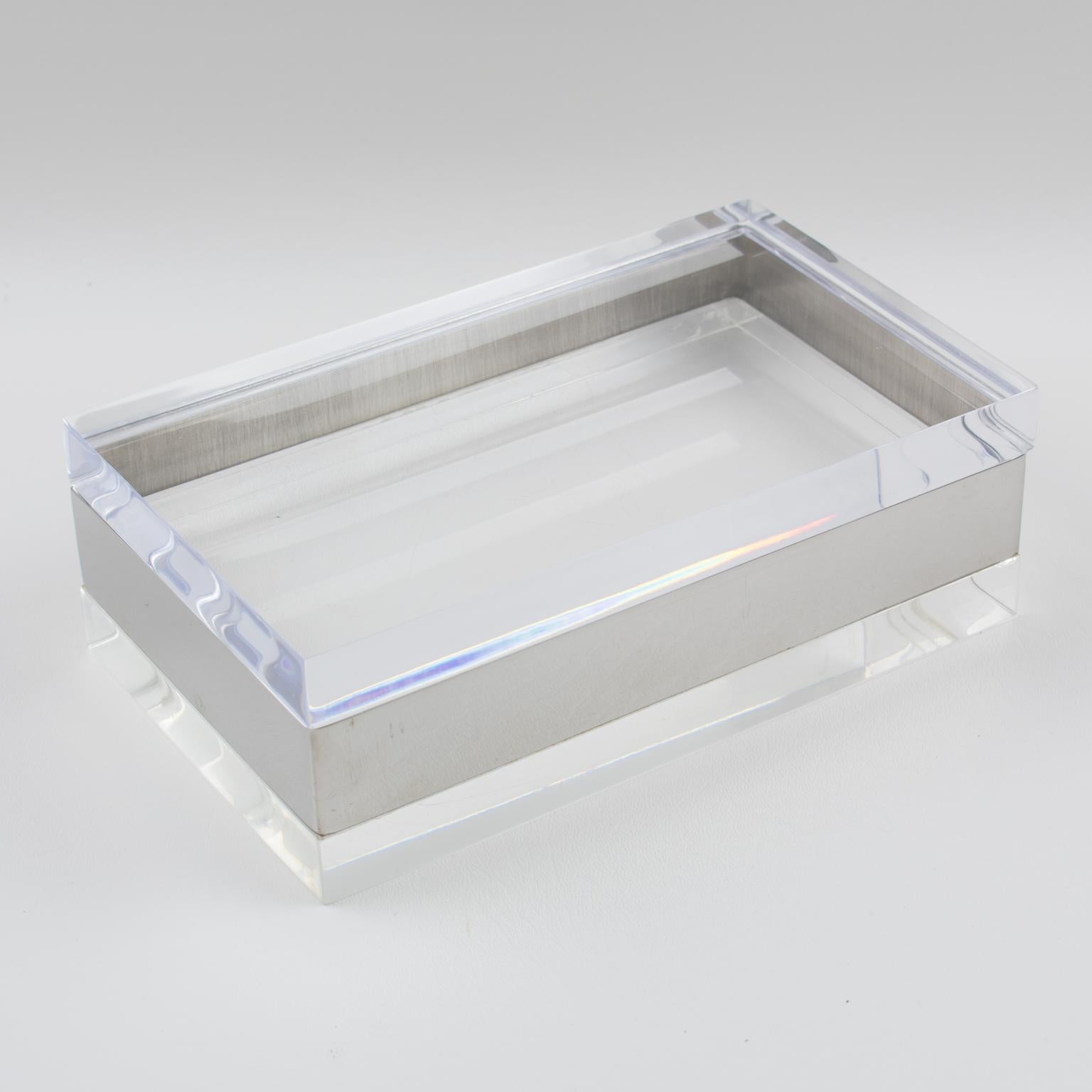 Elegant 1970s rectangular shaped decorative lidded box. Thick crystal clear Lucite or Plexiglass lid and base and chromed metal sides. Very interesting constructed design. No visible maker's mark.
Measurements: 8.07 in. wide (20.5 cm) x 4.94 in.