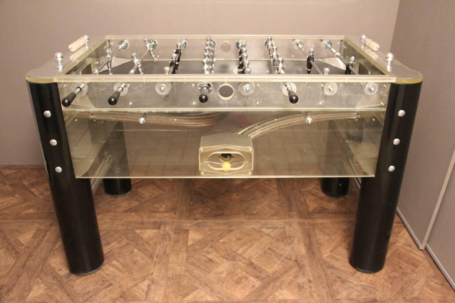 This spectacular and very unique foosball table made in 1970s features all Lucite, mirror polished aluminum sides, black wooden legs and black and polished silver players.
Black playground. All polished aluminum rods, smoothly sliding.
Perfect