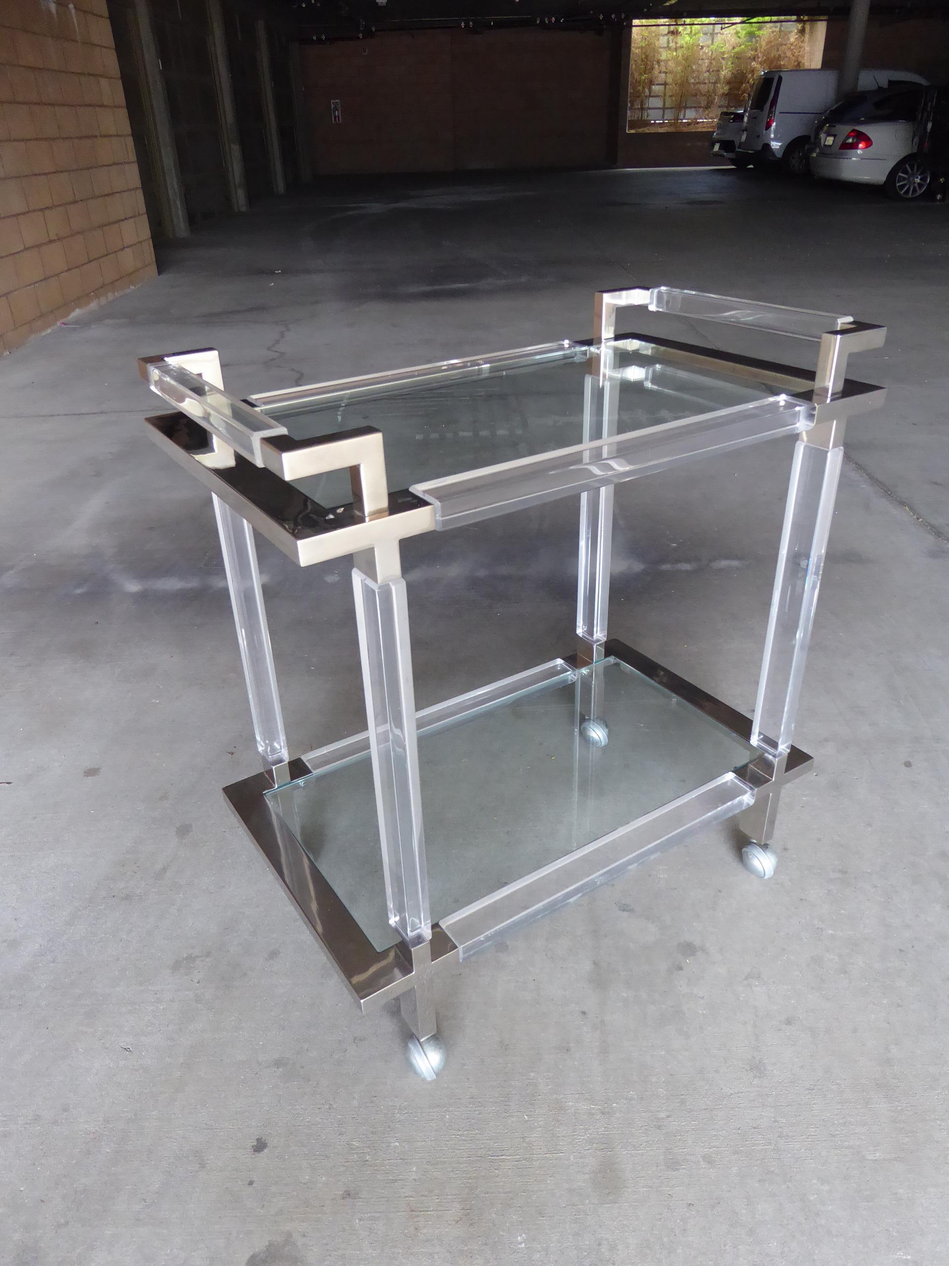 A vintage Lucite, brushed chrome and glass two-tier serving or bar cart designed as part of the metric line by Charles Hollis Jones and made by the Hudson-Rissman Company in the 1970s.